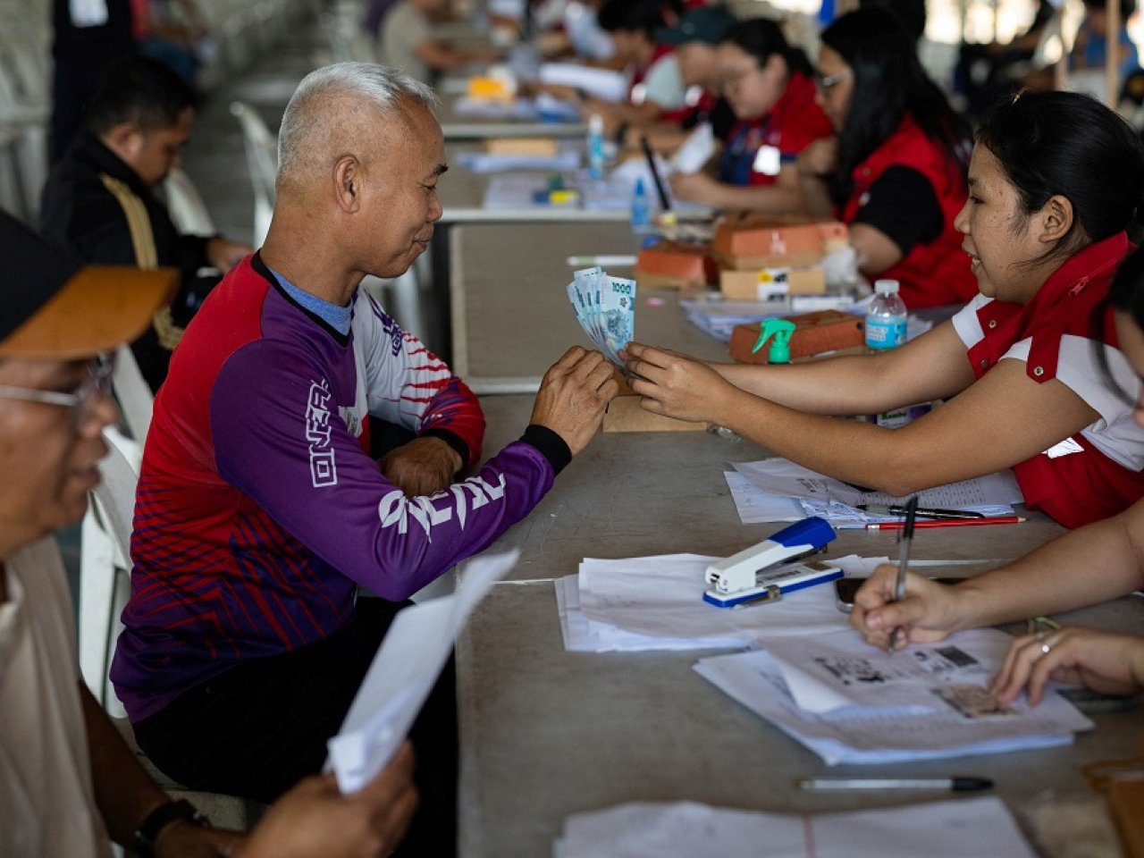 Drivers of ride-hailing services receive cash handouts from the government amid rising fuel prices. Photo: Reuters