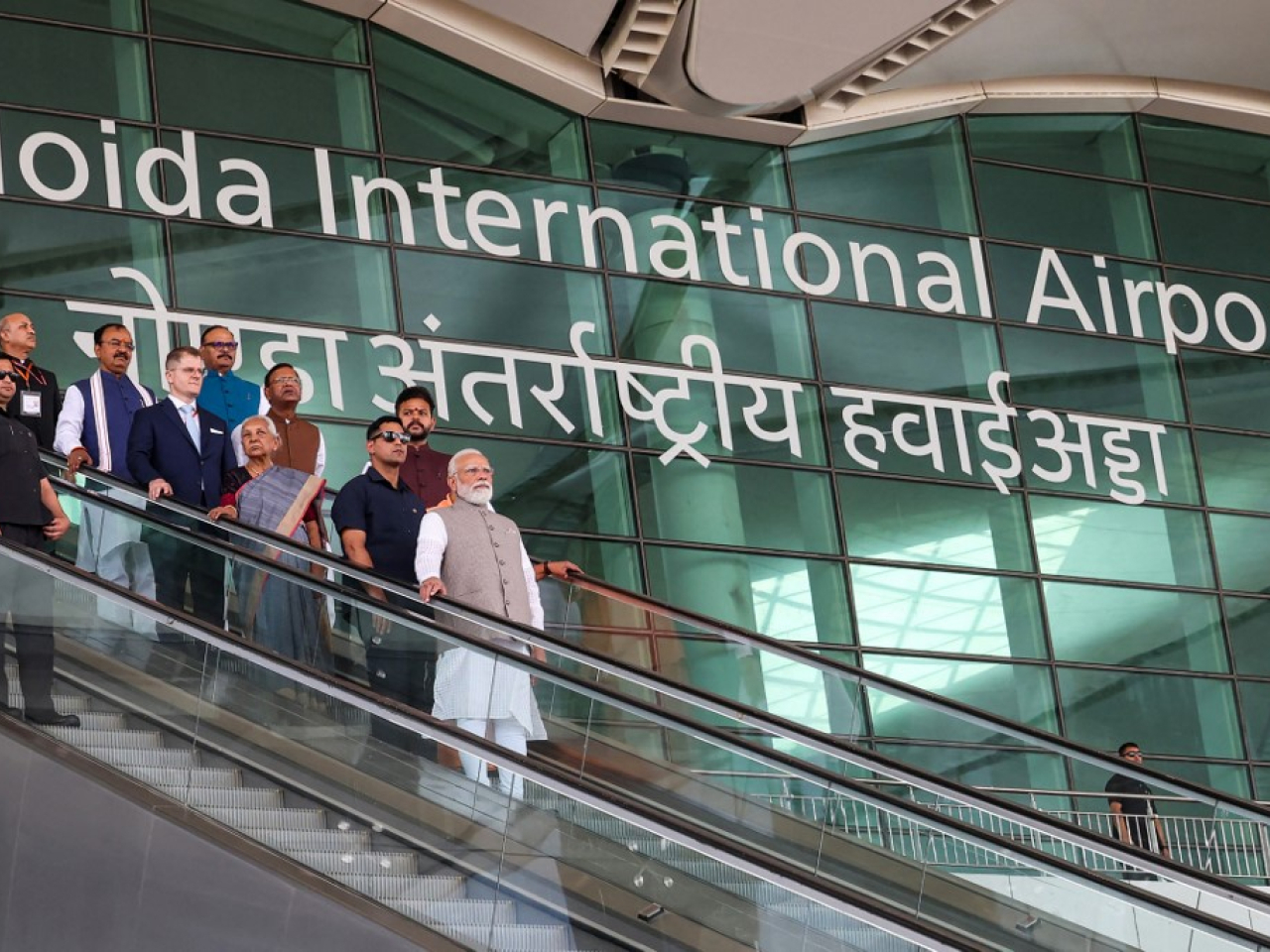 Indian Prime Minister Narendra Modi (centre) riding an escalator after the inauguration of Noida International Airport in Jewar, Uttar Pradesh state. Photo: AFP