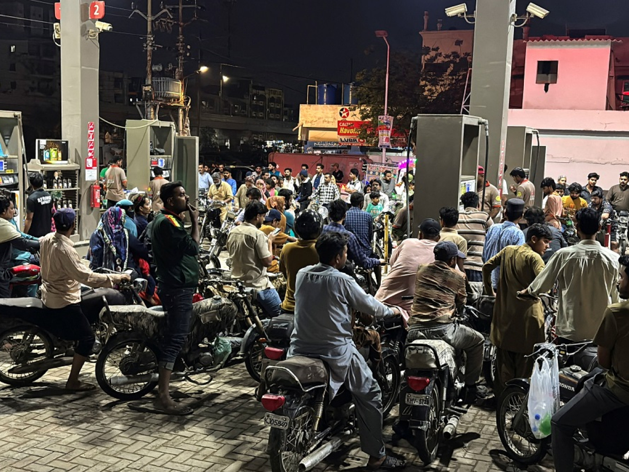Large queues formed at petrol stations after the government hiked the cost of fuel. Photo: Reuters