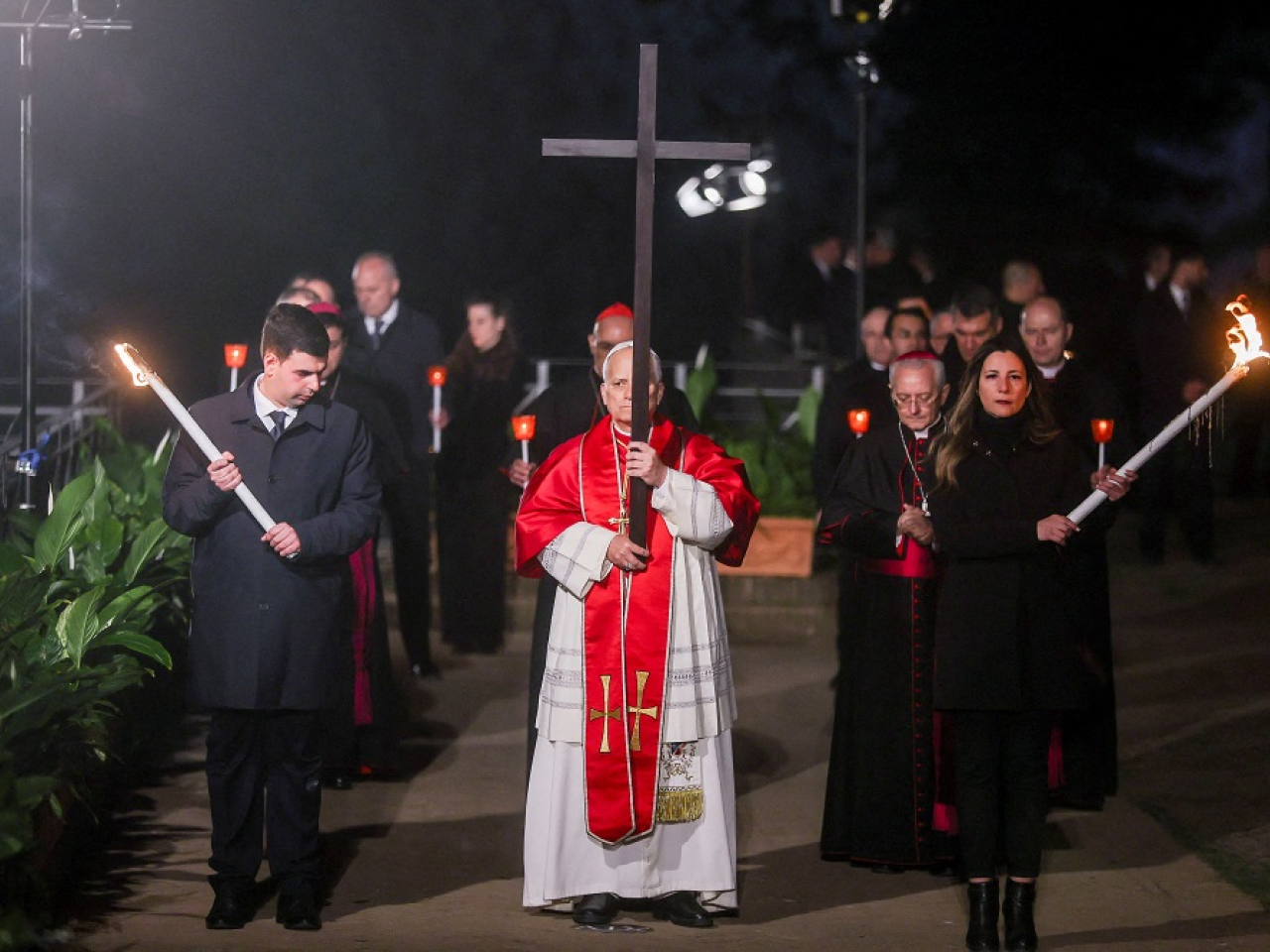 The 70-year-old pontiff carried a large wooden cross through all 14 stations retracing Jesus Christ's path. Photo: Reuters