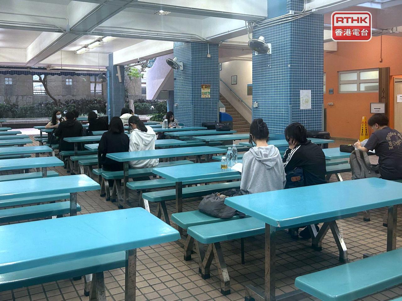 Students are engaged in last-minute preparations for the Chinese language exam at a test centre. Photo: RTHK