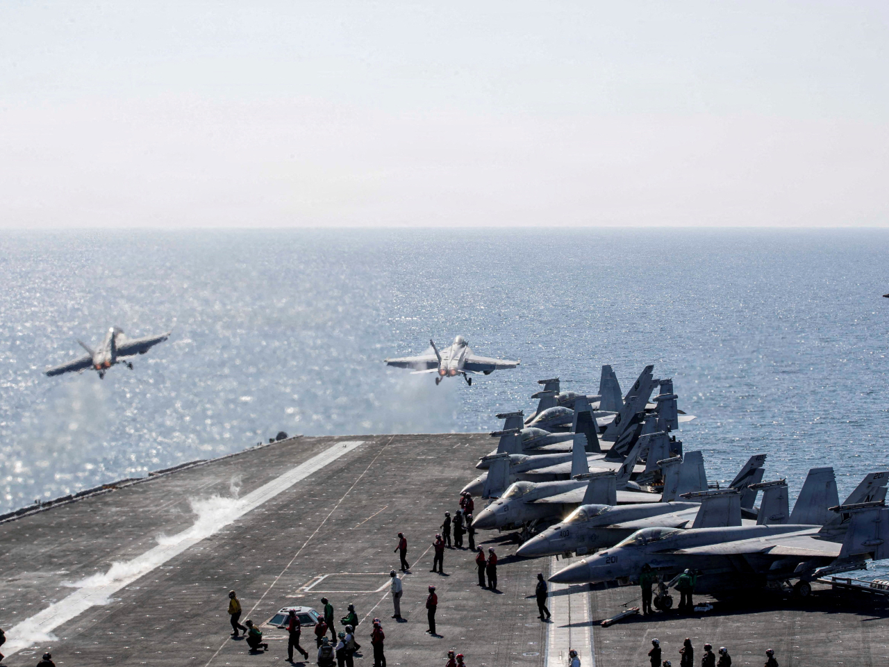 Two F/A-18 Super Hornets launch from the flight deck of the US aircraft carrier USS Abraham Lincoln in the Middle East. File photo: Reuters