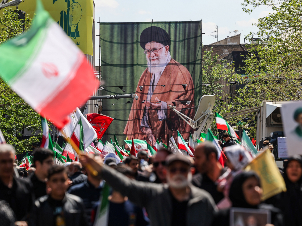 Iranians waved the national flag during a ceremony in Tehran marking 40 days since the death of late Supreme Leader Ayatollah Ali Khamenei. Photo: Reuters