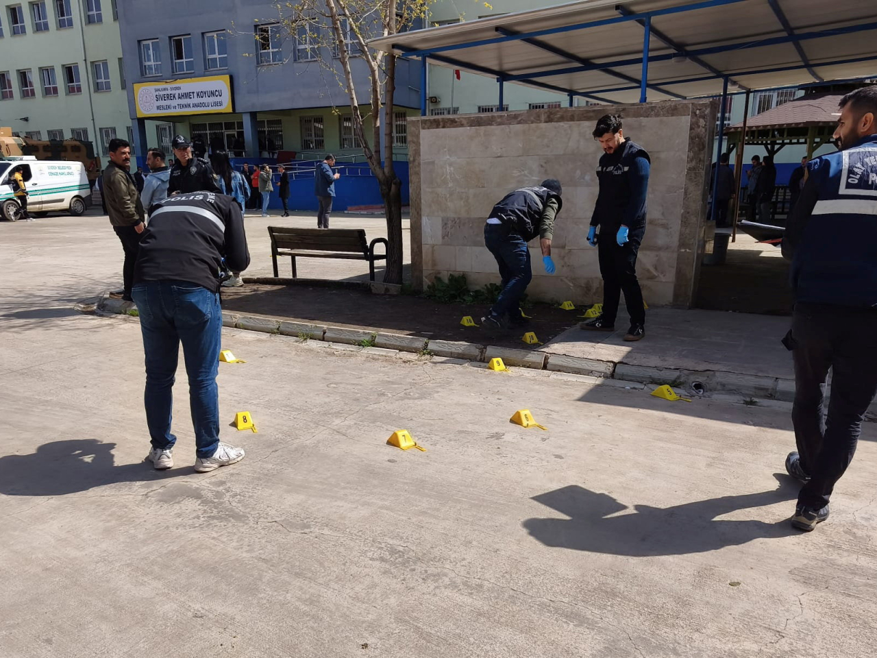 Forensic officers mark spots where shooting victims fell at the high school in Siverek, Sanliurfa province. Photo: Reuters