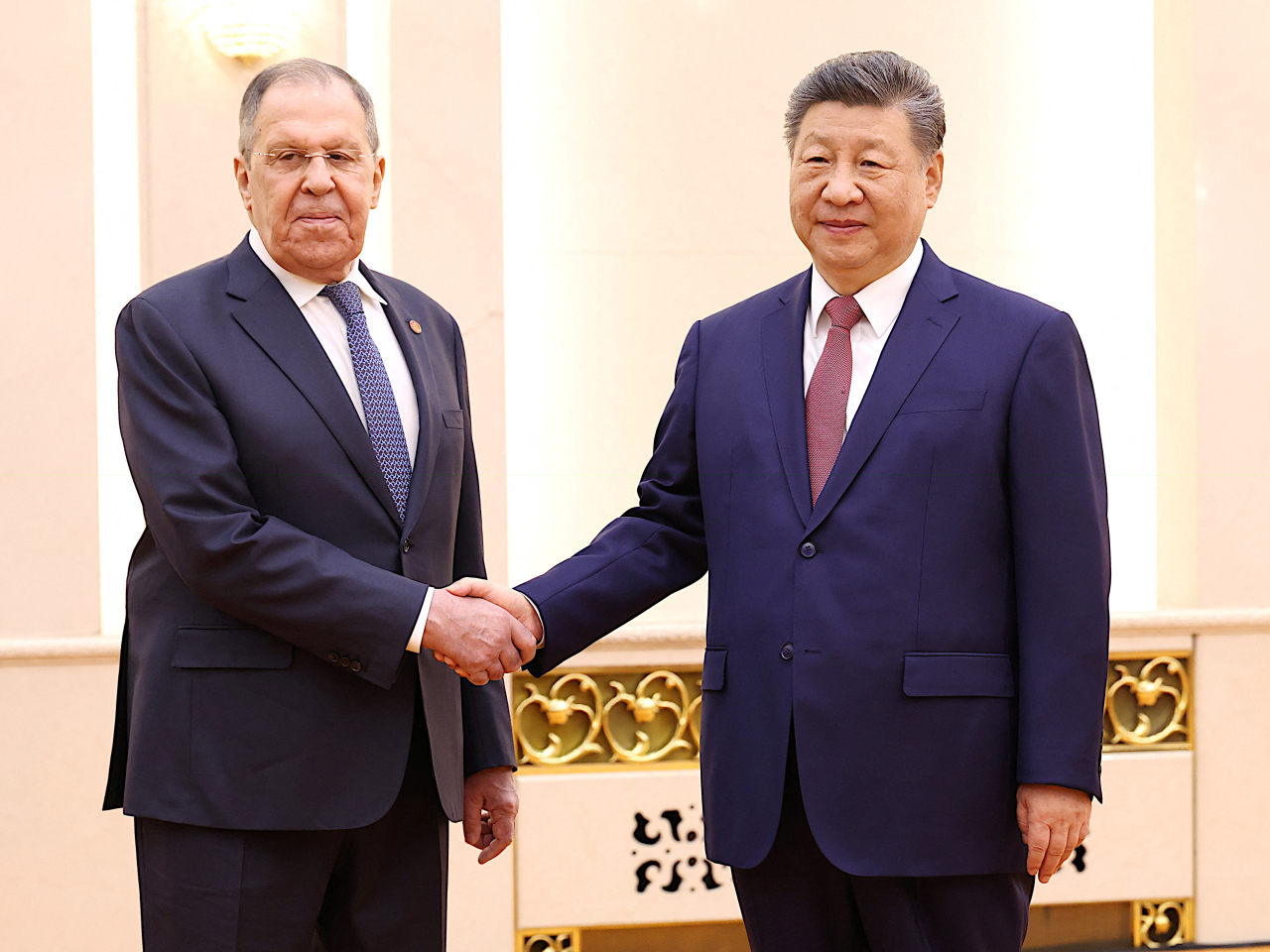 President Xi Jinping and Russia's Foreign Minister Sergei Lavrov shake hands at the Great Hall of the People in Beijing. Photo: Reuters