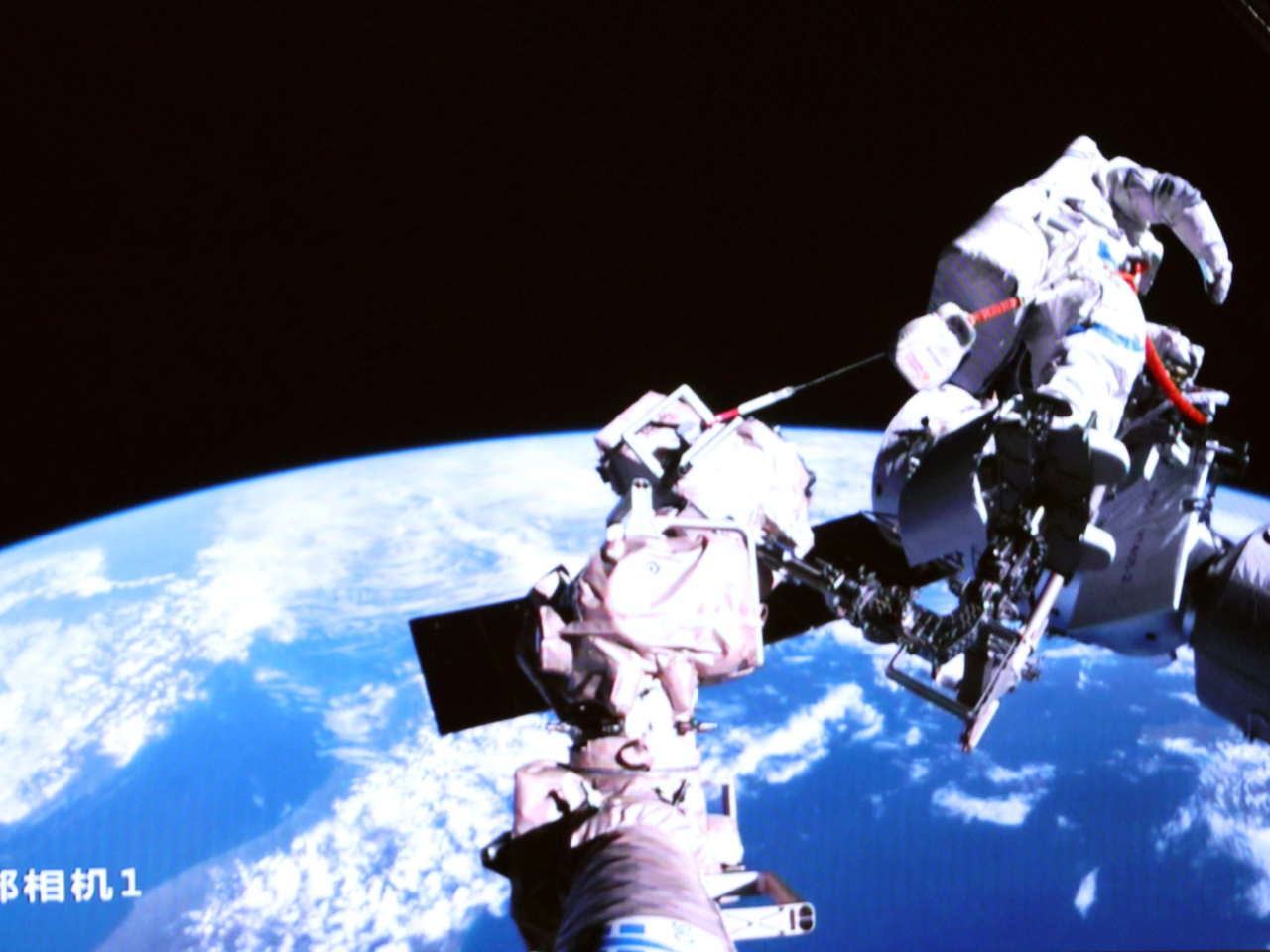 Astronauts Zhang Lu and Wu Fei carried out the extravehicular work to install space debris protection equipment and inspect space-walk equipment. Photo: Xinhua