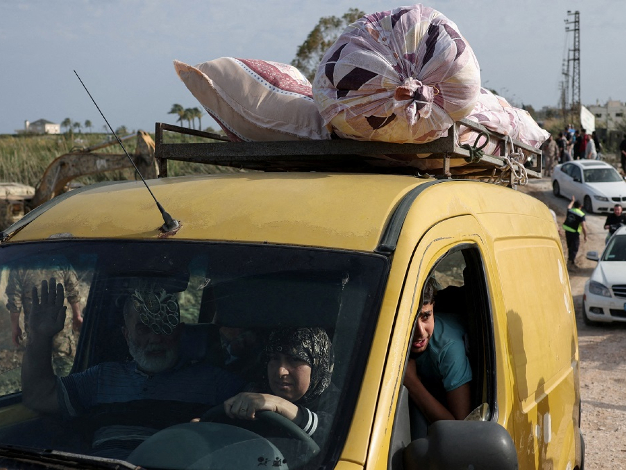 Displaced people make their way back home crossing a bridge in Qasmiyeh linking southern Lebanon to the rest of the country. Photo: Reuters