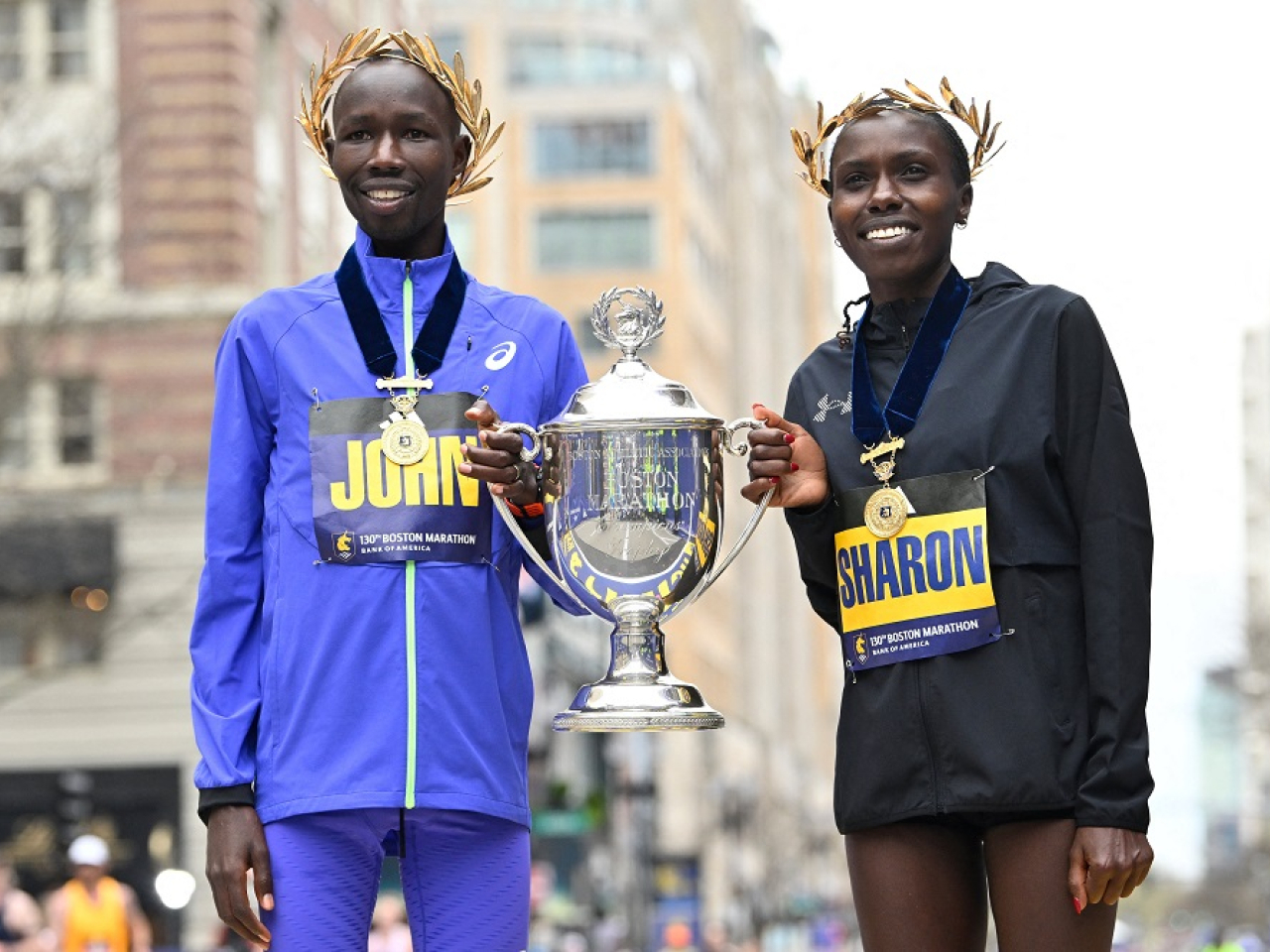 John Korir and Sharon Lokedi pose with the winners cup at the 130th running of the Boston Marathon. Photo: Reuters