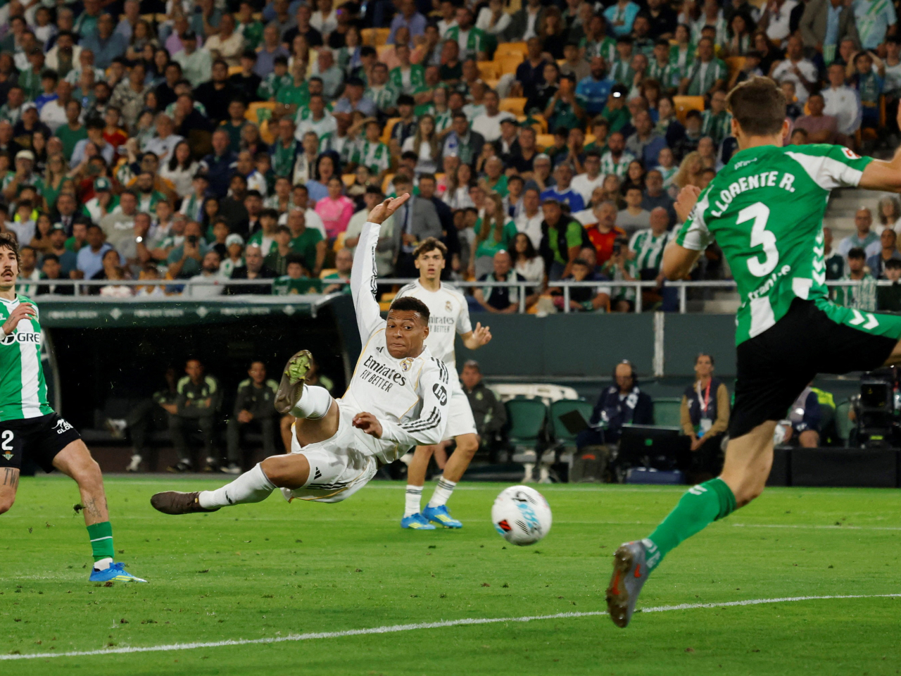Kylian Mbappe takes a gymnastic shot on goal in Real Madrid's 1-1 draw against Real Betis at the Estadio de La Cartuja in Seville. Photo: Reuters