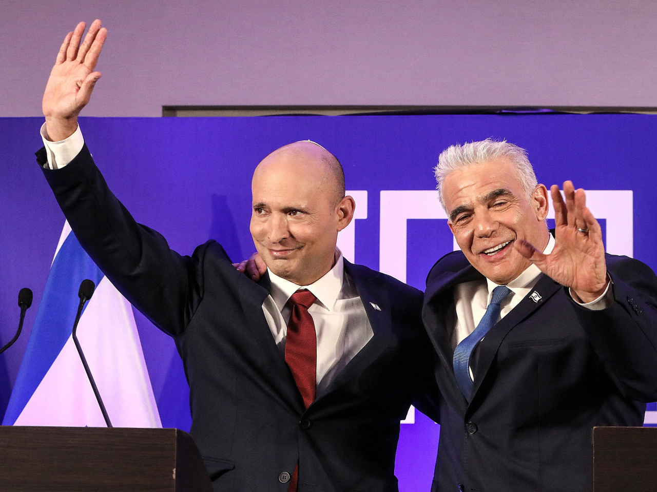 貝內特（左）和拉皮德（右）宣布，兩人領導的政黨將會合併為新的團結黨。（路透社）