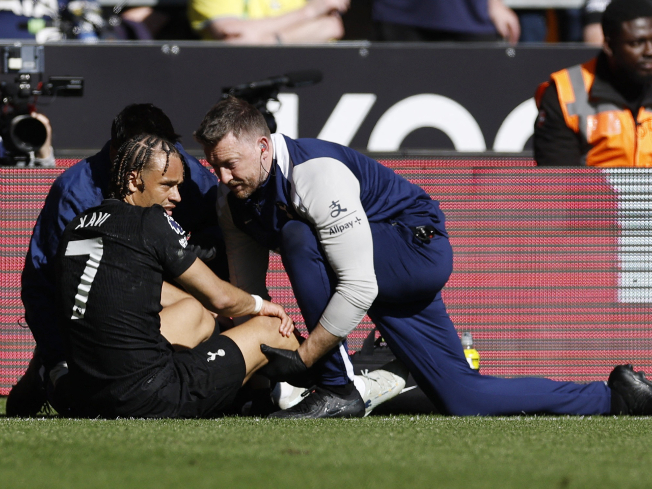 Xavi Simons receives medical attention after sustaining a knee injury in Spurs' 1-0 win over Wolves. Photo: Reuters
