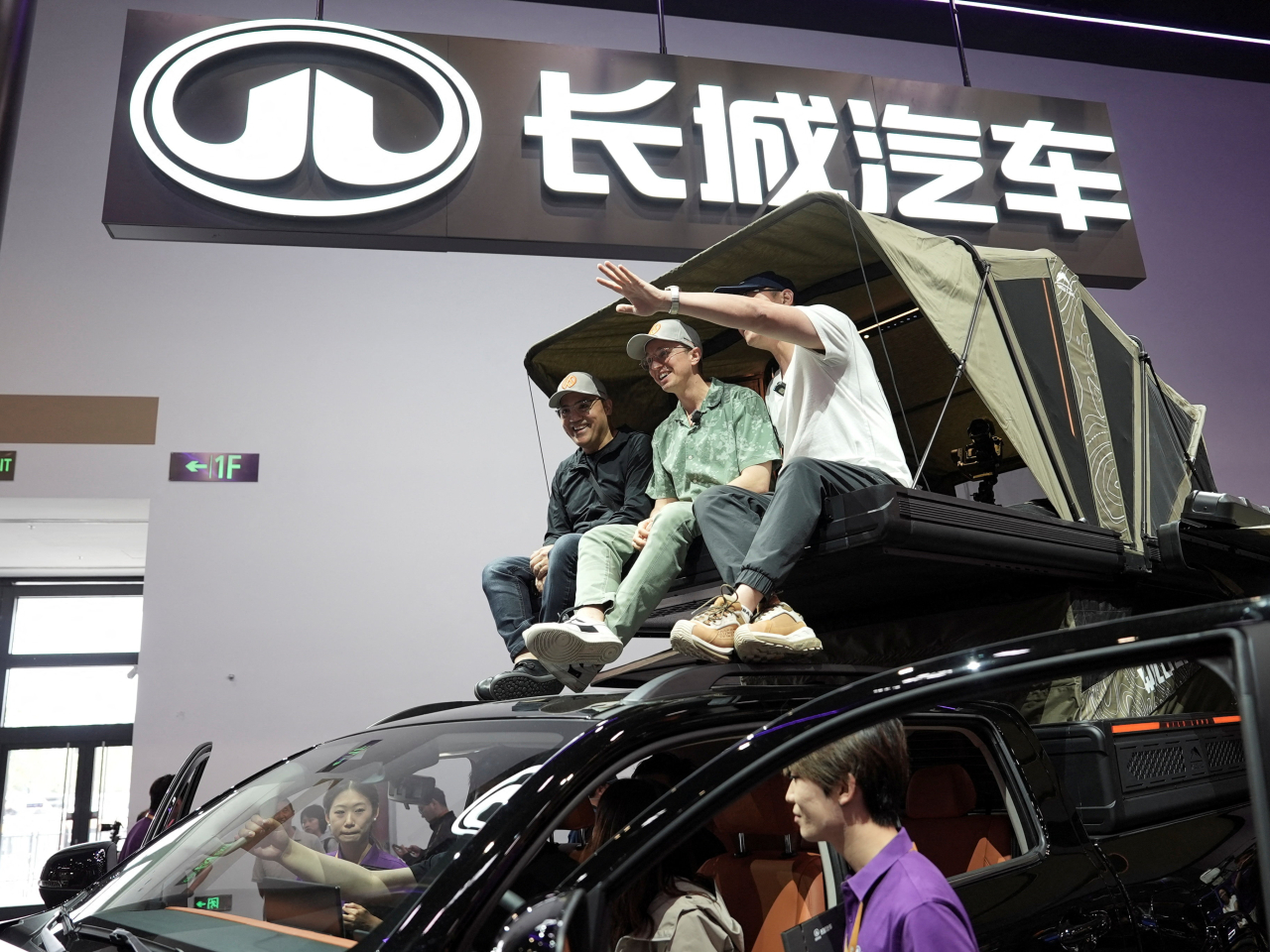 American YouTuber Ethan Robertson, top centre, sits on a Great Wall Motor Hi4-T off-roader at the Beijing Auto Show. Photo: Reuters