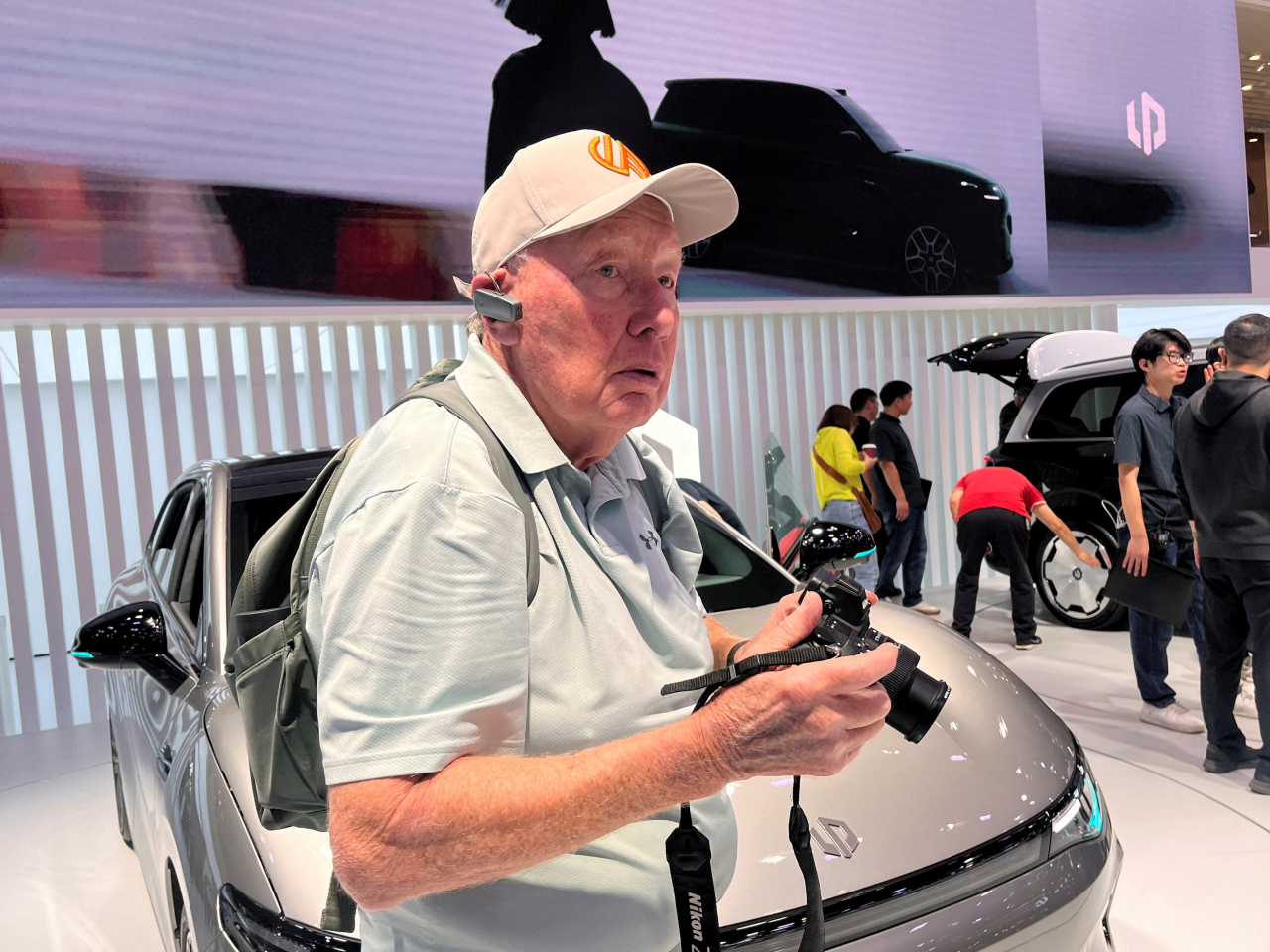 New Zealand retiree John Cordell at the Leapmotor booth during the tour by Ethan Robertson at the Beijing Auto Show. Photo: Reuters