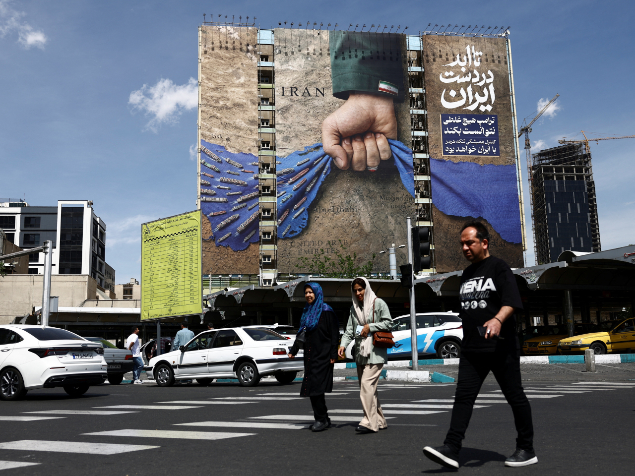 A larger-than-life billboard in Tehran brings home the point that Iran has a chokehold on shipping through the Strait of Hormuz. Photo: Reuters