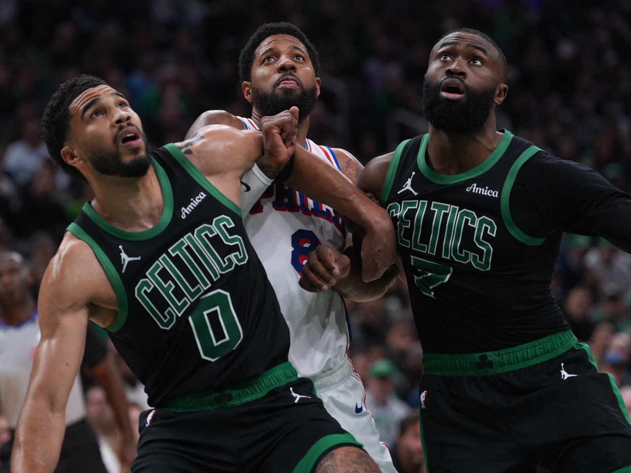 Boston Celtics forward Jayson Tatum (0) and guard Jaylen Brown (7) look for the rebound against Philadelphia 76ers forward Paul George (8). Photo: Reuters
