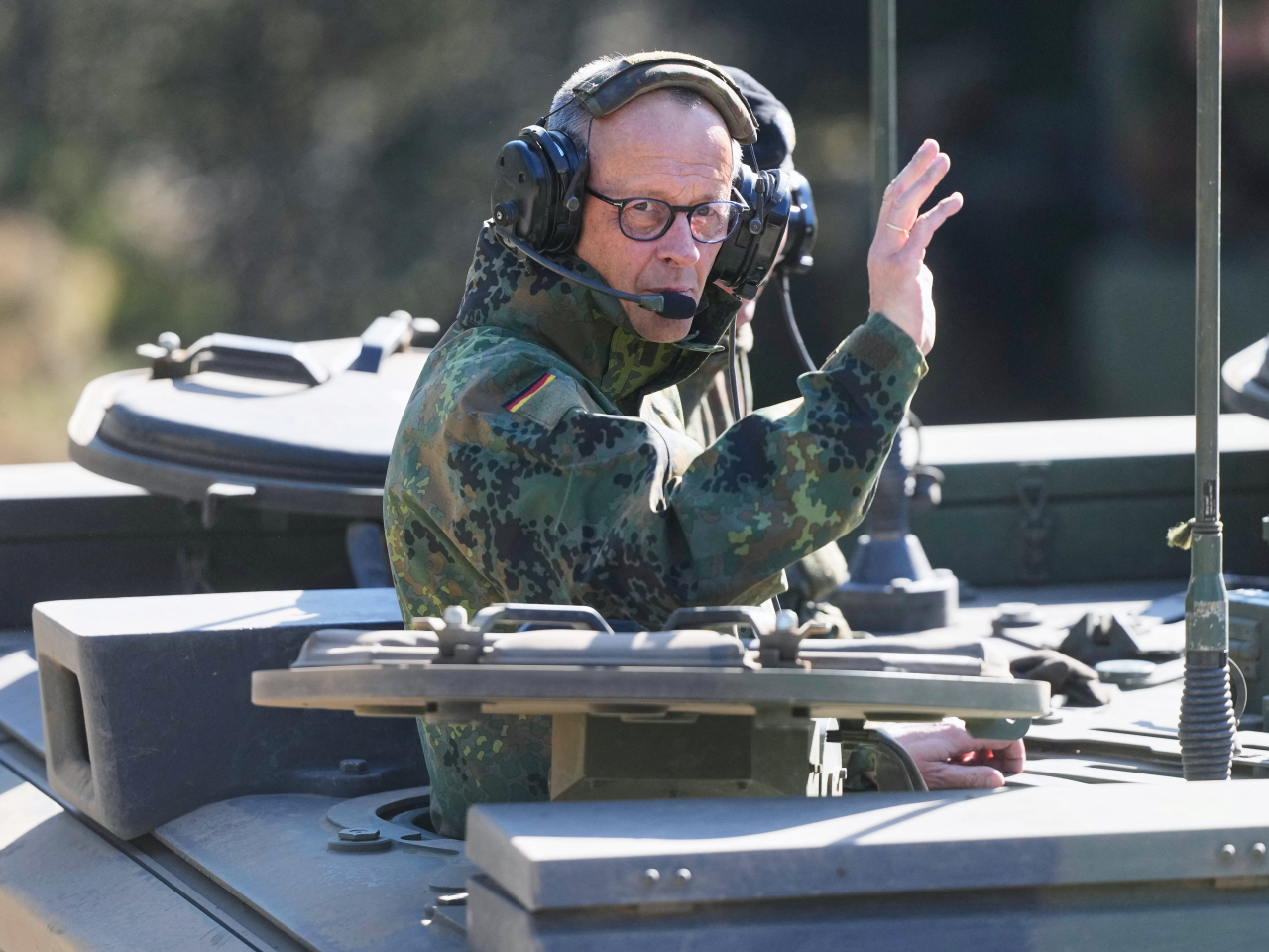 Friedrich Merz rides in a Boxer armoured fighting vehicle Boxer at a Bundeswehr base in Munster, Germany. Photo: Reuters