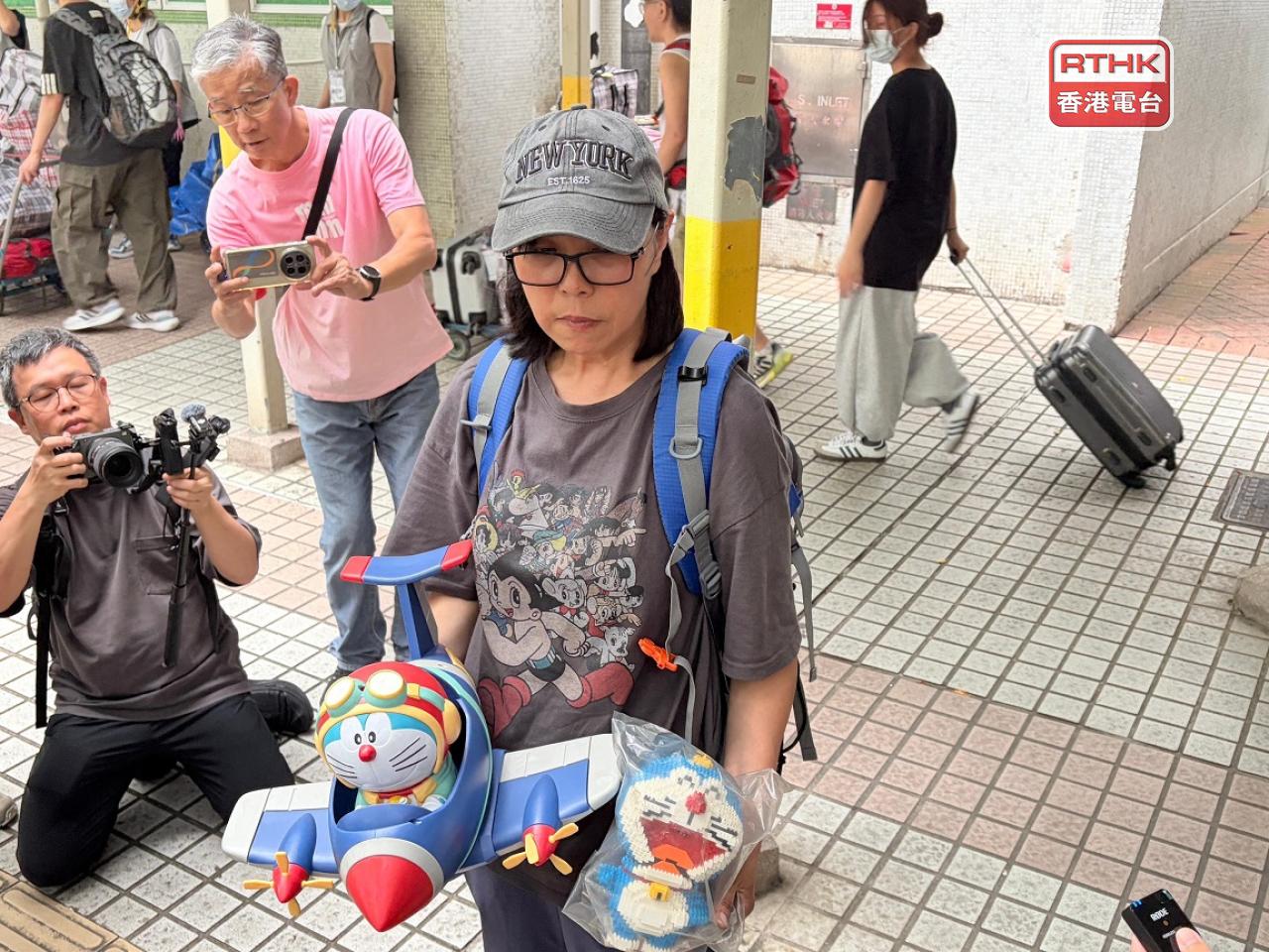A resident surnamed Ho is visibly upset by how badly damaged her flat was. Photo: RTHK