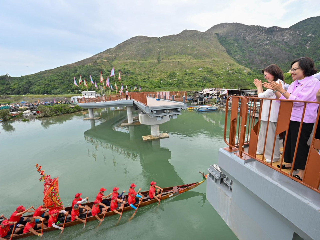 鹽田橋為全港首條伸縮式開合橋，甯漢豪（左）和麥美娟（右）在鹽田橋上觀賞表演。（政府新聞處）