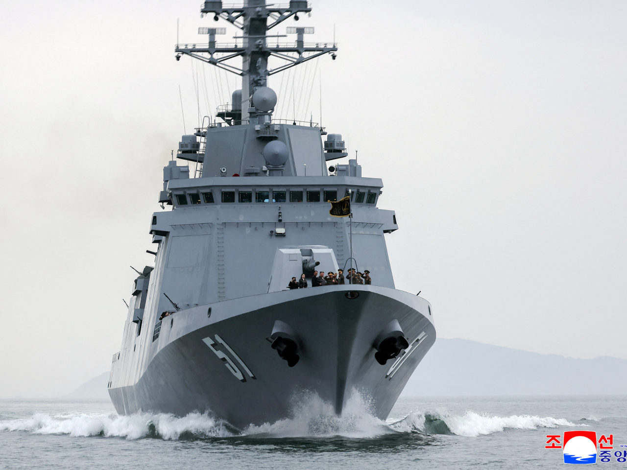 Kim Jong-un is surrounded by naval officers at the bow of the 5,000-tonne destroyer Choe Hyon being tested for deployment. Photo: KCNA/Reuters