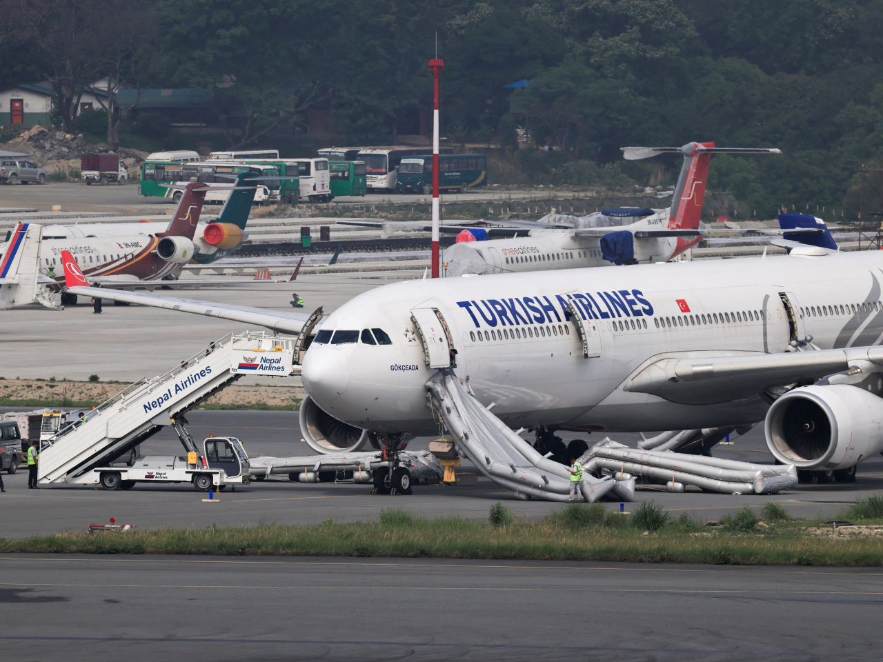 The Turkish Airlines A330 sits on Tribhuvan International Airport's tarmac after the evacuation and the fire is put out. Photo: Reuters