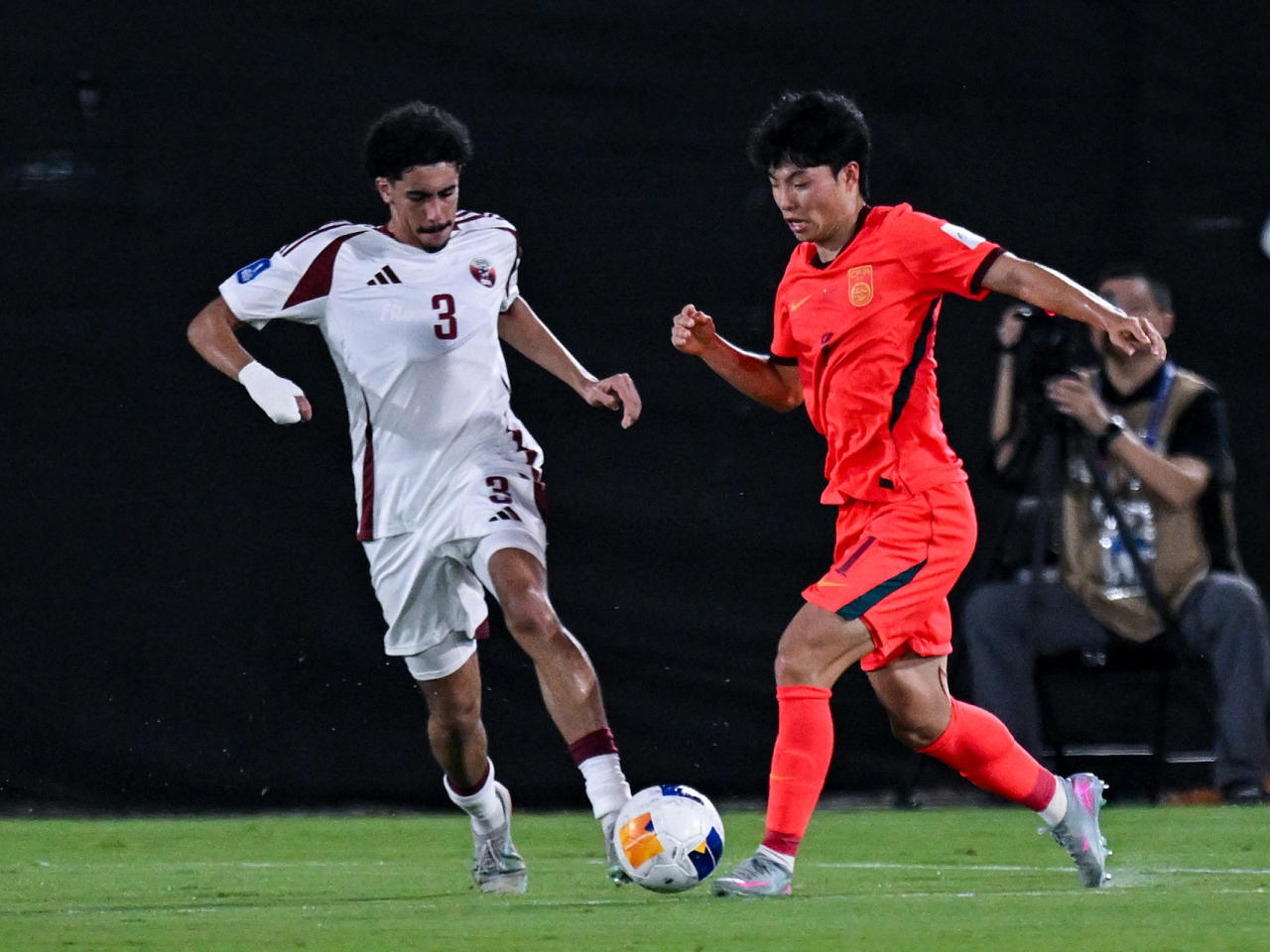 He Sifan (right) fired China into the lead on 14 minutes, helping to secure their return to the FIFA U17 World Cup this November. Photo: Xinhua