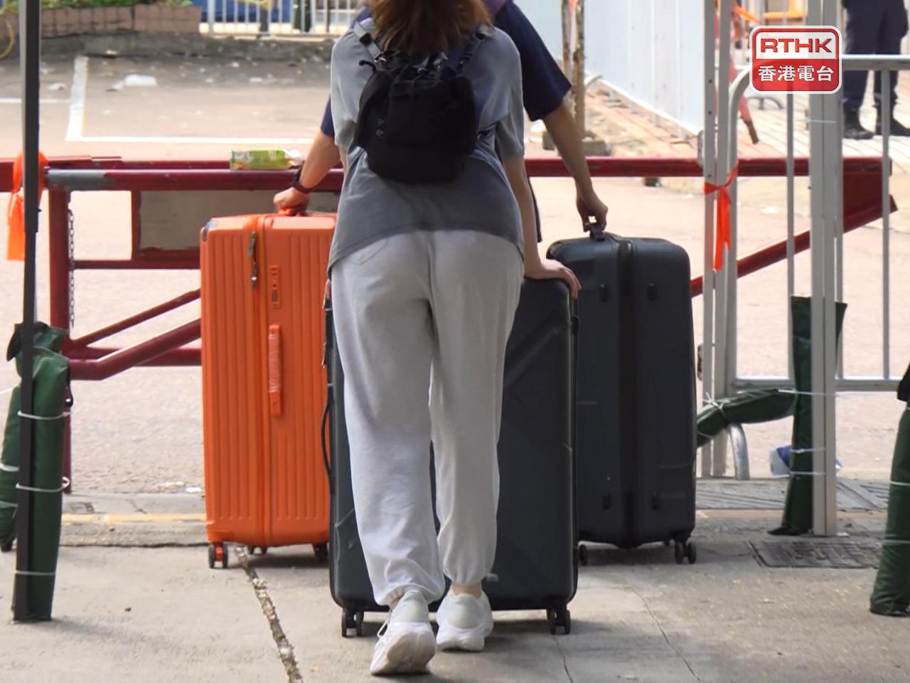The morning saw registered residents arrive with suitcases, hand trucks and cardboard boxes, preparing to head back to their units. Photo: RTHK