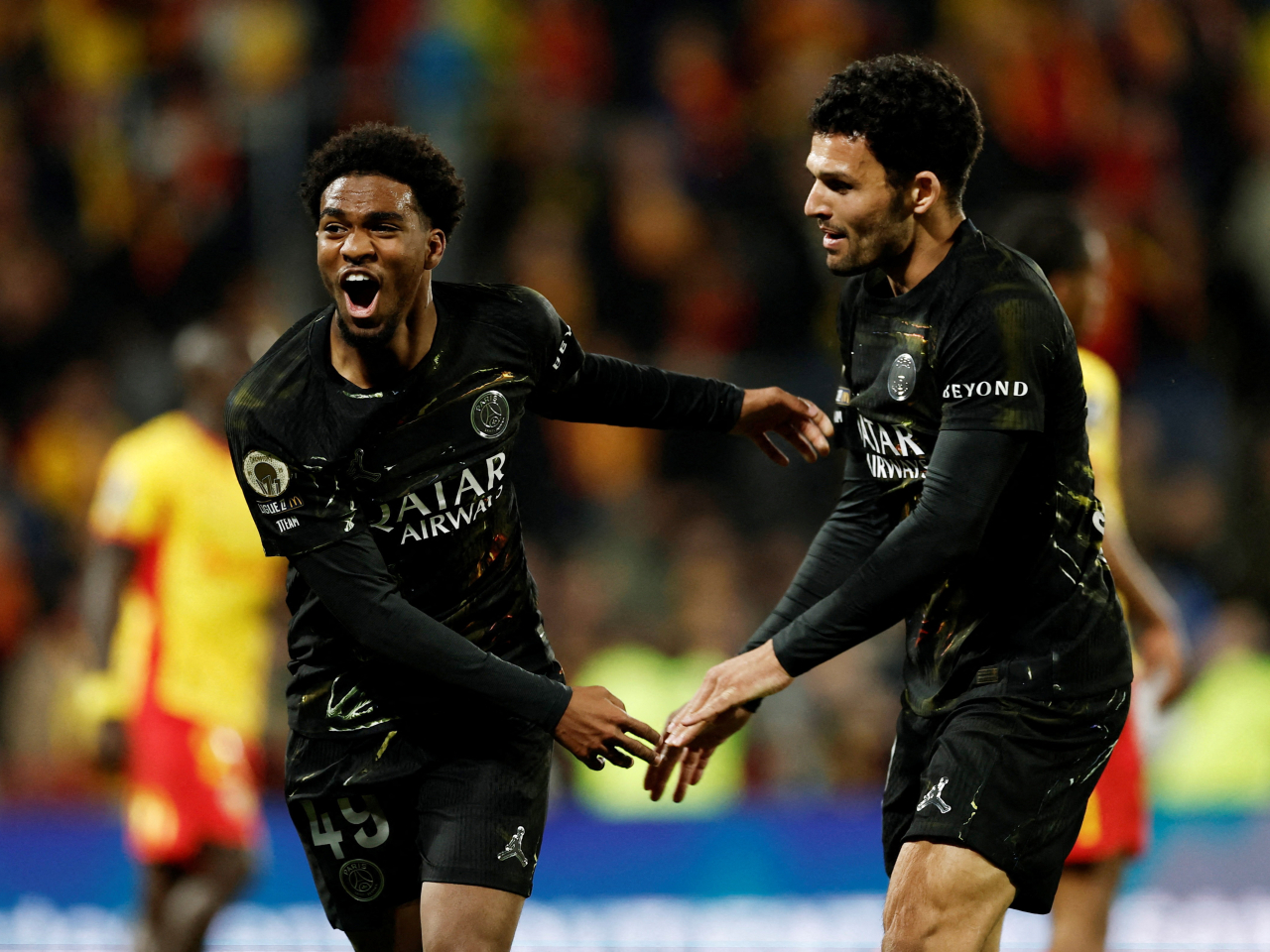 Ibrahim Mbaye, left, scored late in the second half to all but wrap up PSG's title victory. Photo: Reuters