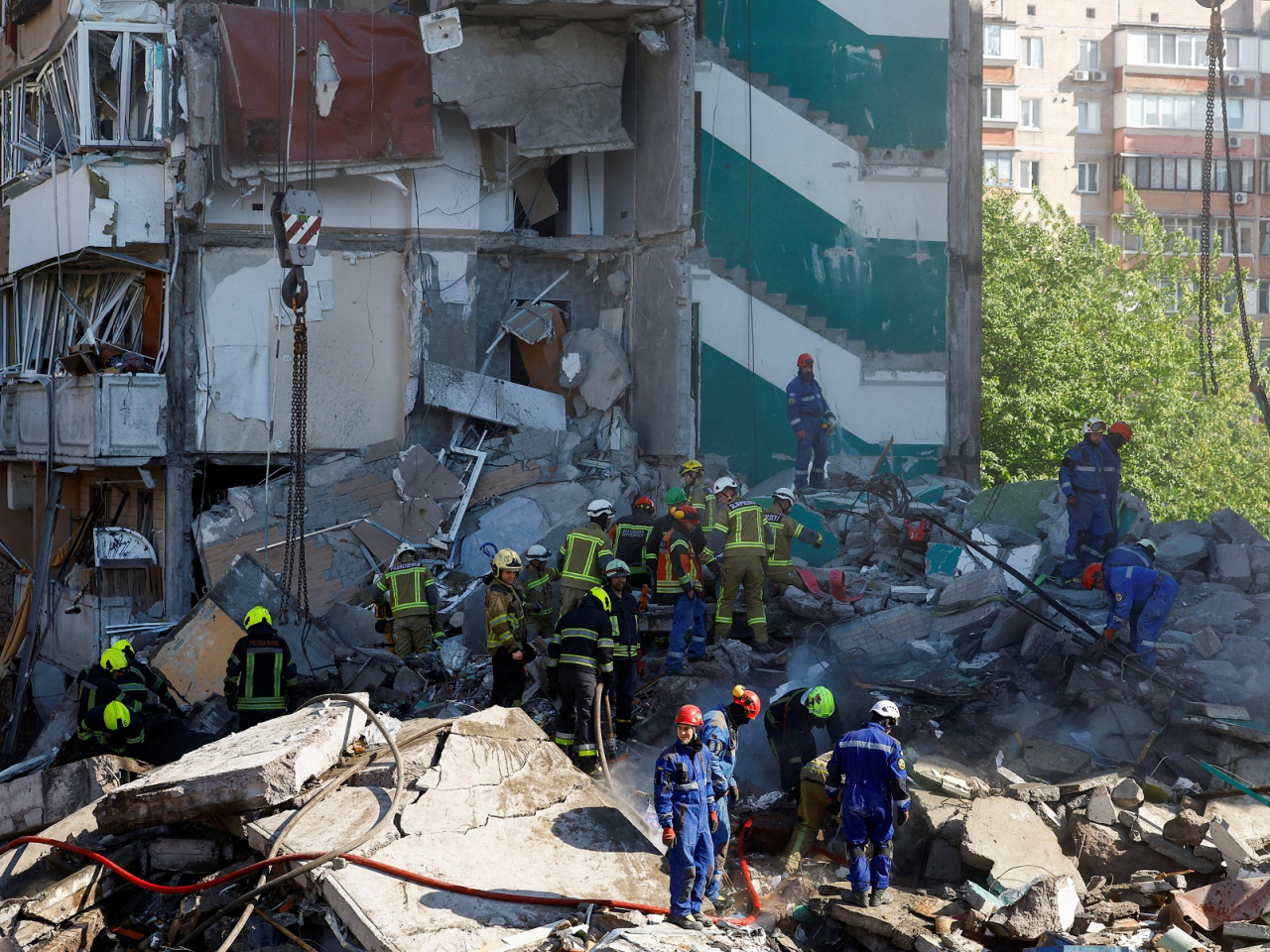 Rescuers work at the site of an apartment building damaged during Russian missile and drone strikes on Kyiv. Photo: Reuters