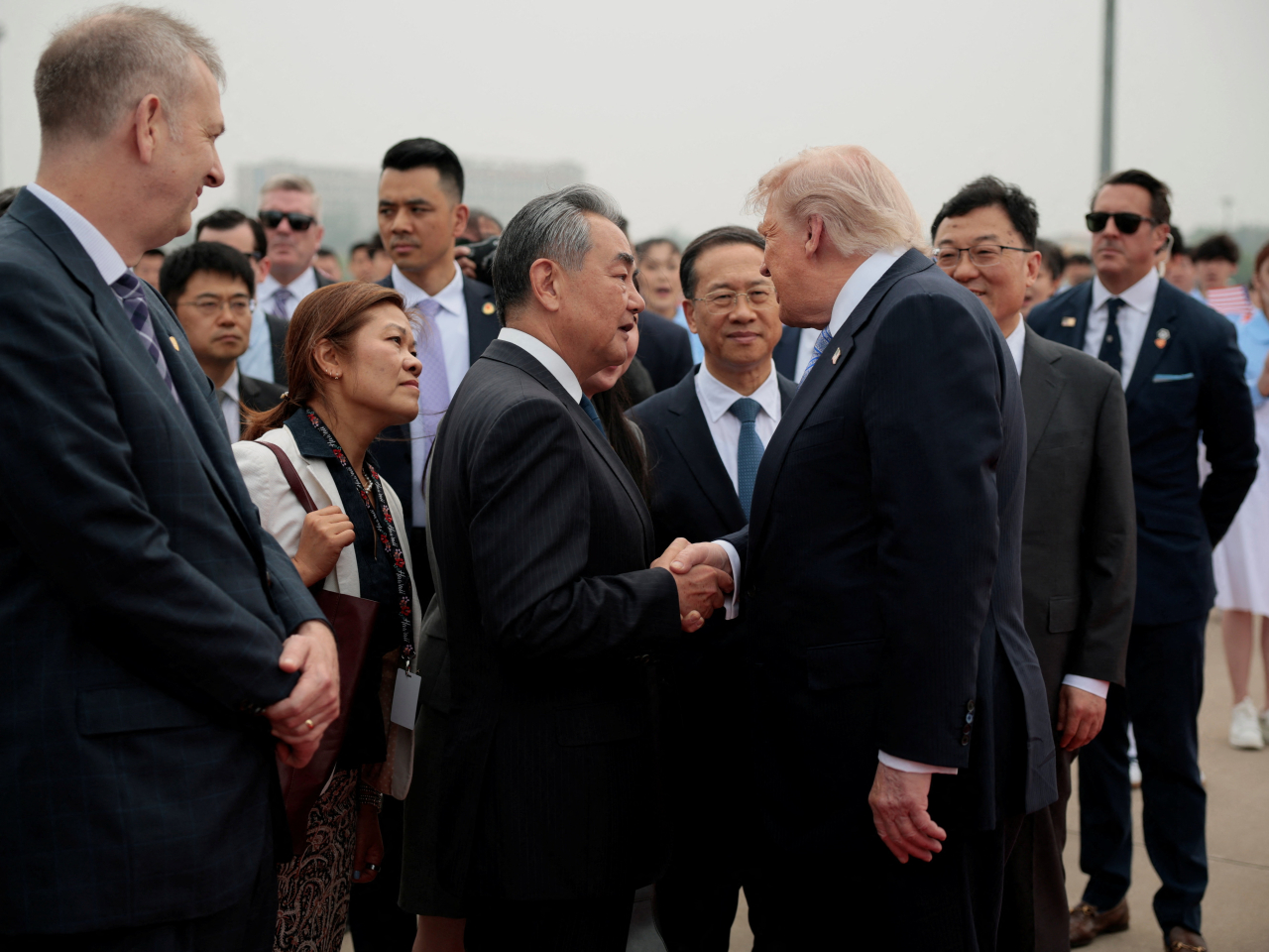 Donald Trump talks with Foreign Minister Wang Yi before boarding Air Force One for his return home. Photo: Reuters