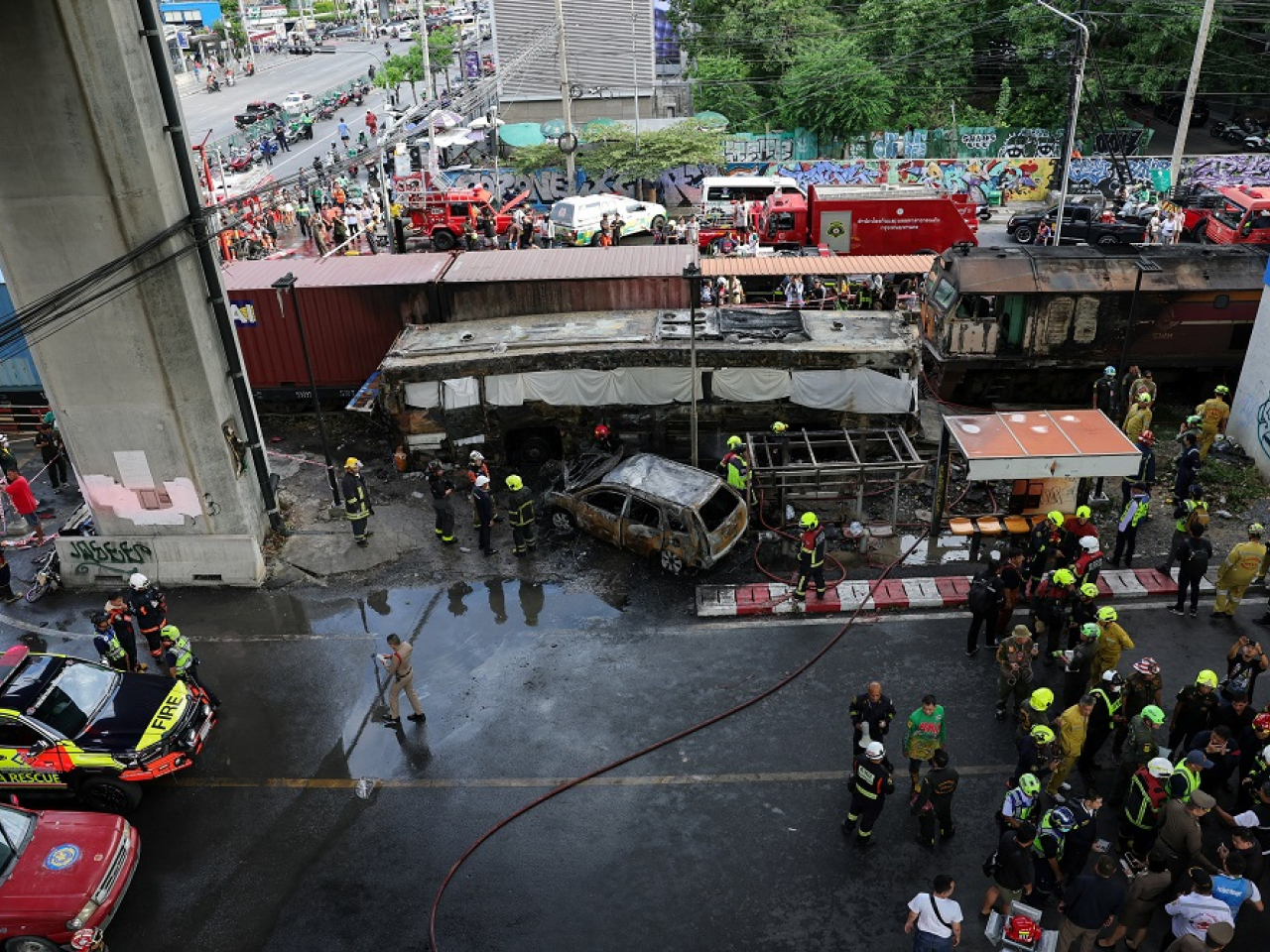Emergency services work at the site where a train collided with a bus in Bangkok, Thailand. Photo: Reuters