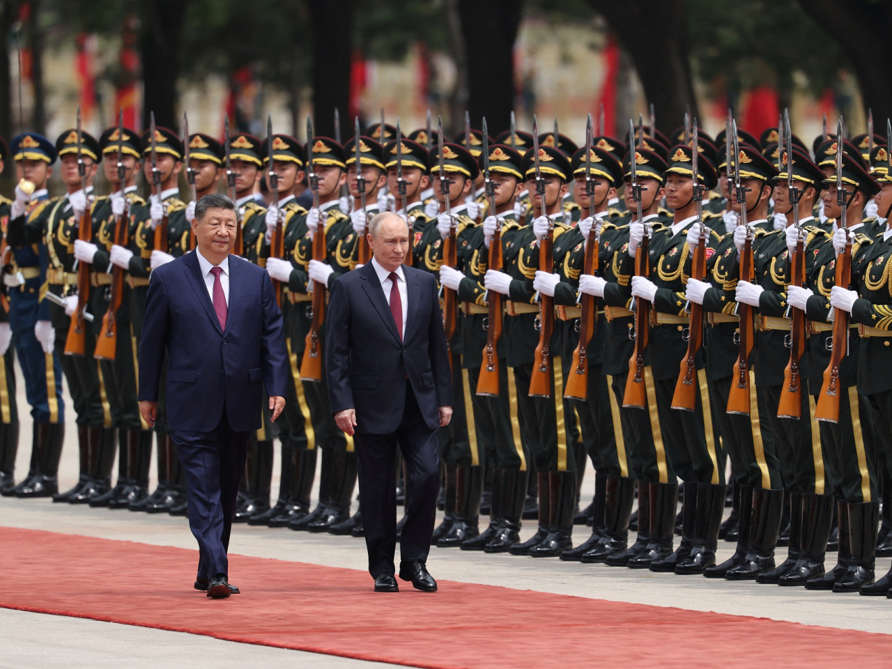 Presidents Xi Jinping and Vladimir Putin walk down the red carpet and inspect a guard of honour outside the Great Hall of the People. Photo: Reuters