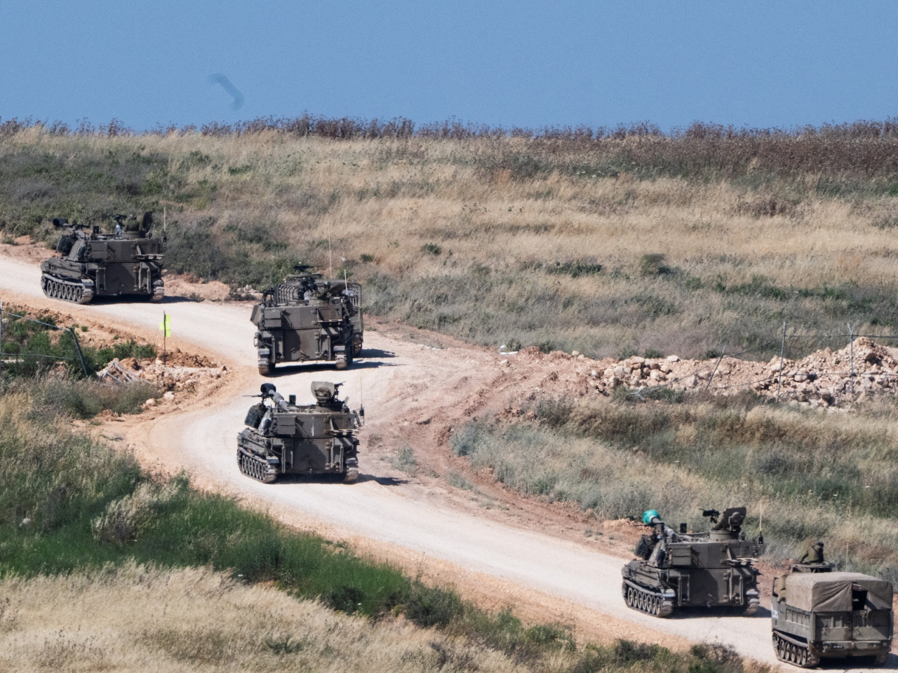 An Israeli military artillary unit drives into Lebanon after crossing the Israeli‑Lebanese border. Photo: Reuters