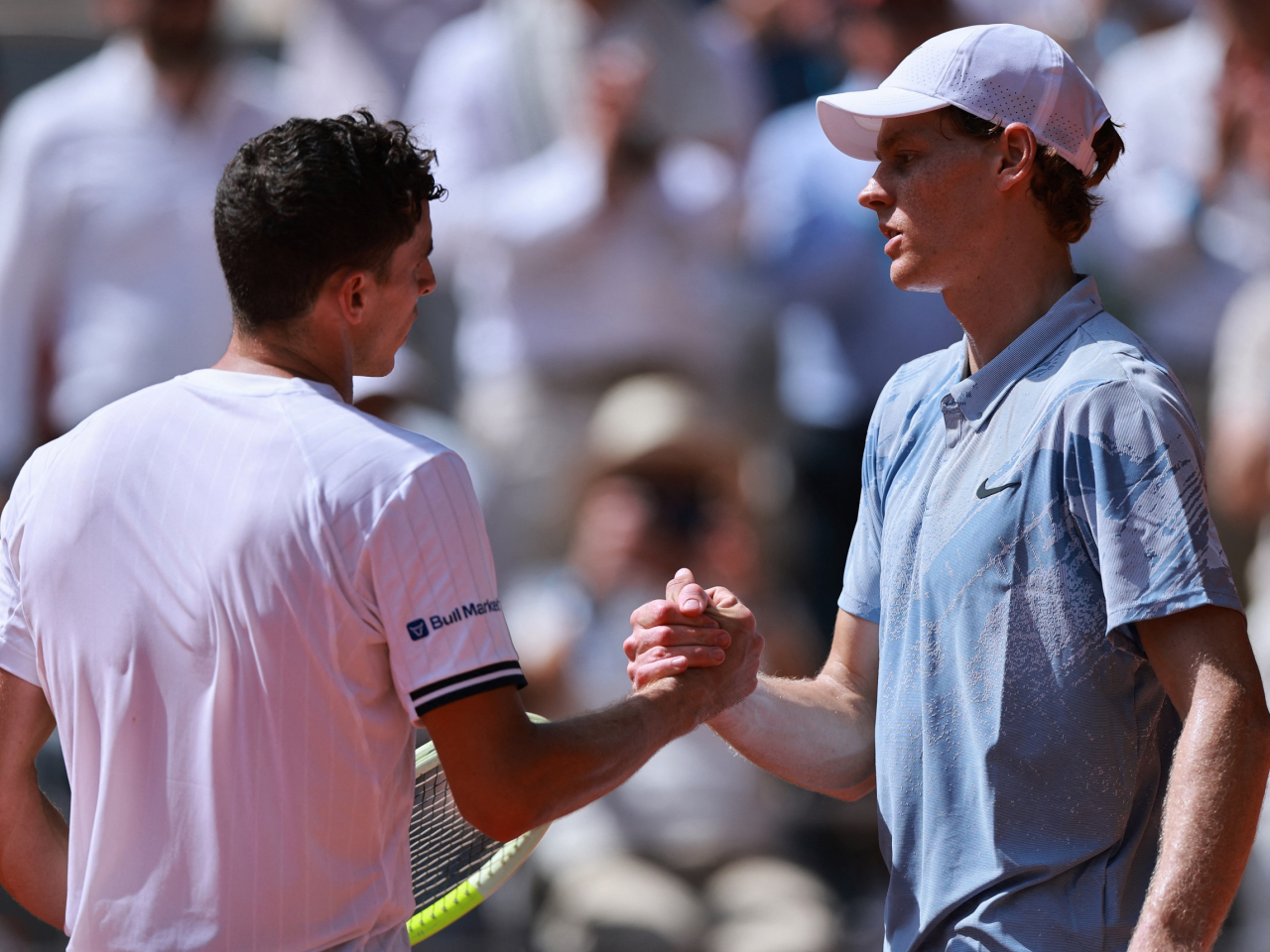 Juan Manuel Cerundolo and Jannik Sinner shake hands after their second round match. Photo: Reuters
