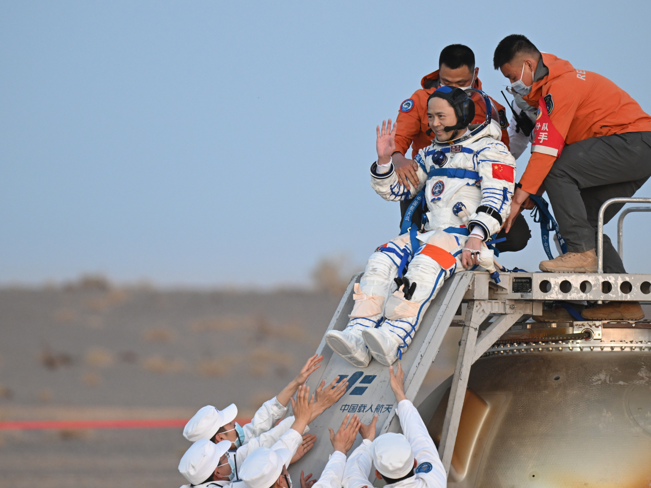 Mission commander Zhang Lu is the first astronaut to be carried out of the Shenzhou-22 spaceship's return capsule. Photo: Xinhua