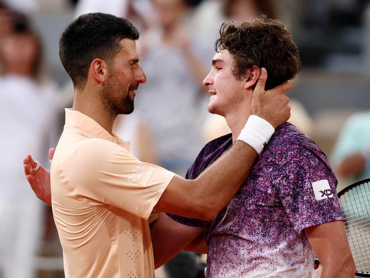 Novak Djokovic congratulates Joao Fonseca after falling to the Brazilian prodigy at Roland Garros. Photo: Reuters