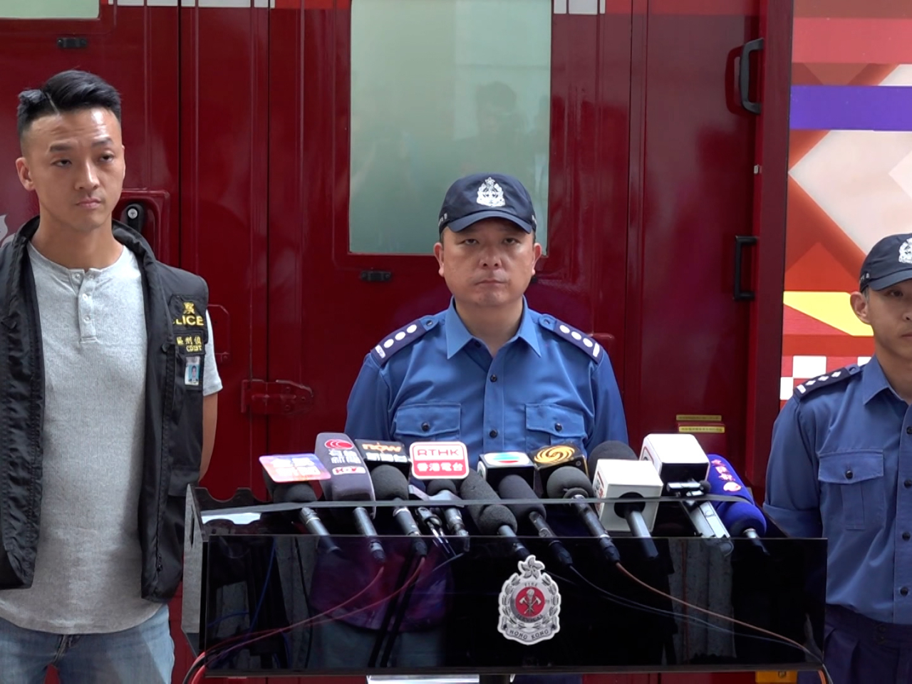 Mo Shan-hoi (centre) from the Fire Services Department says firefighters found three people unconscious in the flat. Photo: RTHK