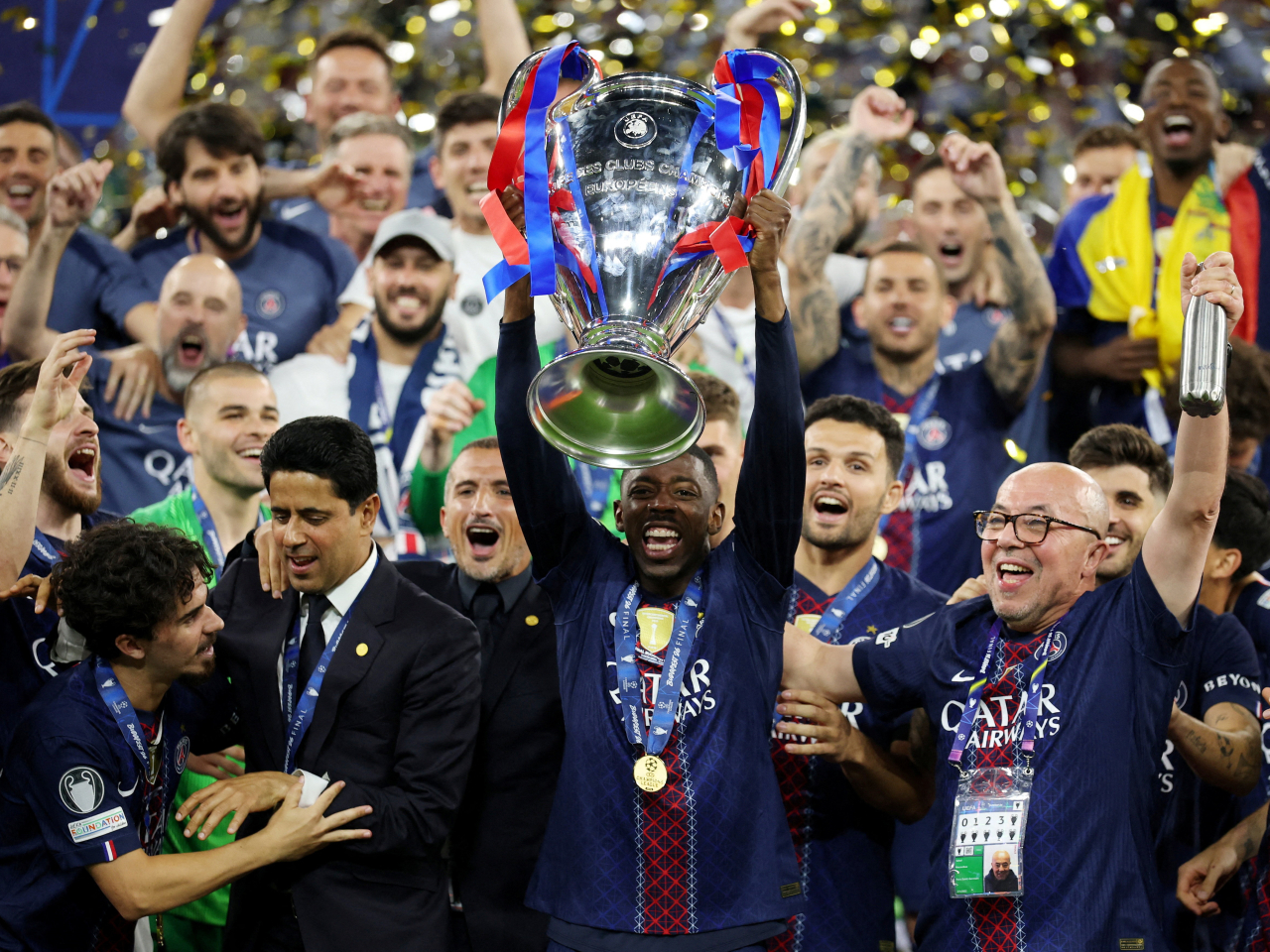 Paris St Germain's Ousmane Dembele with the trophy as he celebrates with players and staff after winning the Champions League. Photo: Reuters