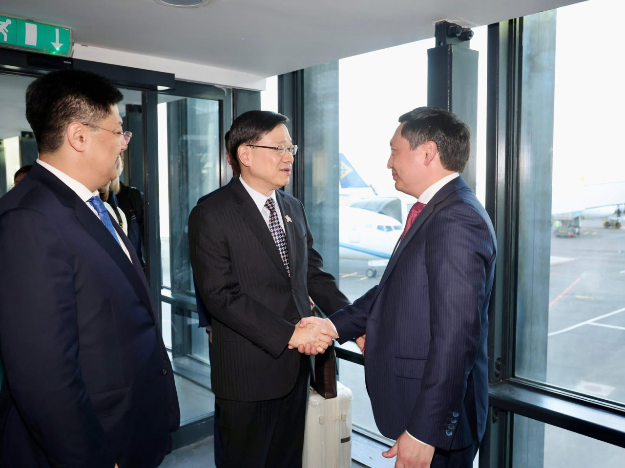 The chief executive is greeted at the airport by Assan Darbayev, Vice Minister of National Economy of Kazakhstan. Photo courtesy of John Lee's Facebook