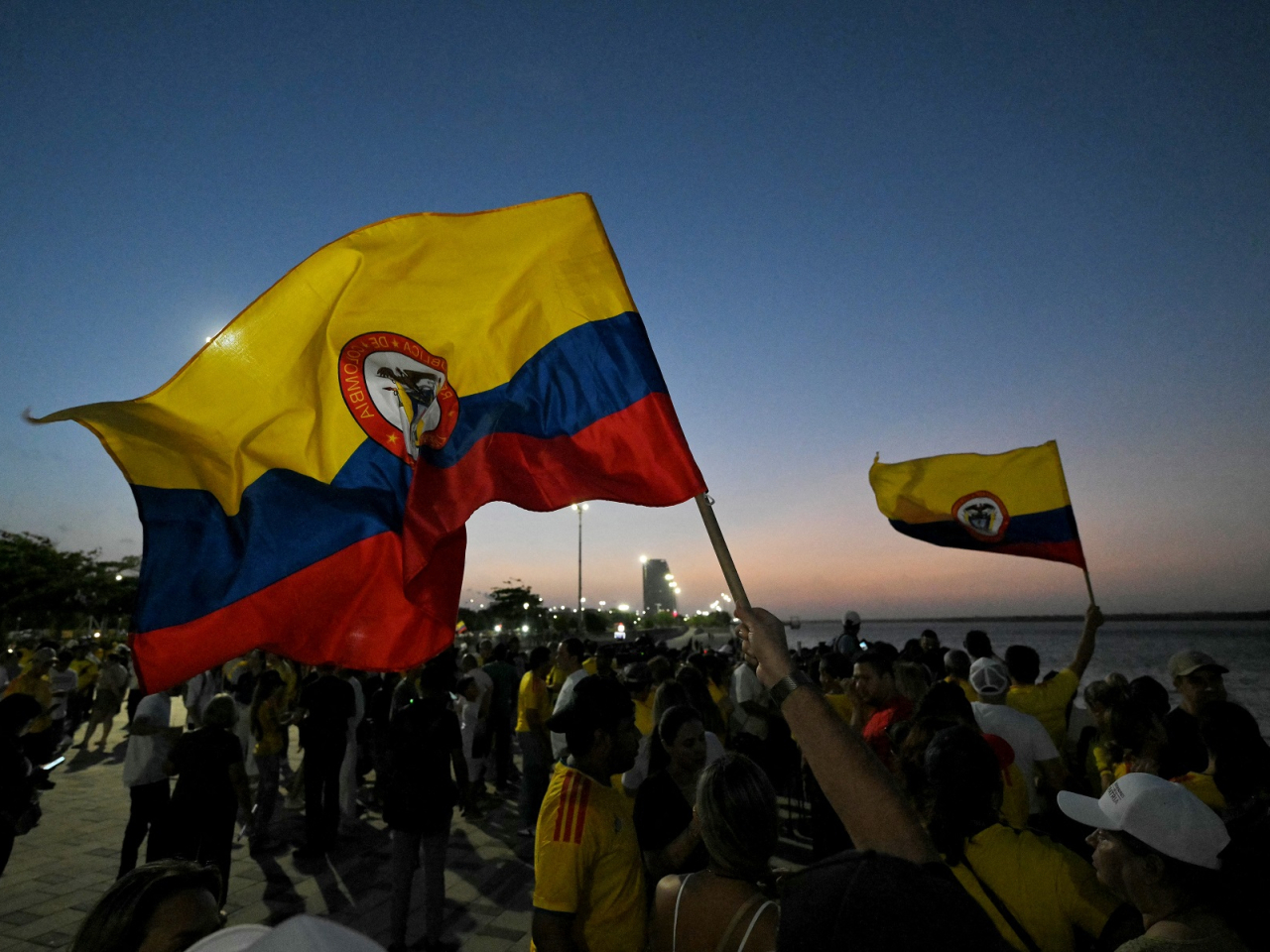 Supporters of presidential candidate Abelardo de la Espriella wave national flags as they celebrate exit poll results. Photo: AFP