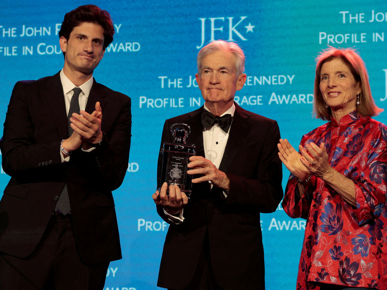 Jerome Powell holds the award in a presentation by Caroline Kennedy and her son, Jack Schlossberg in Boston. Photo: Reuters