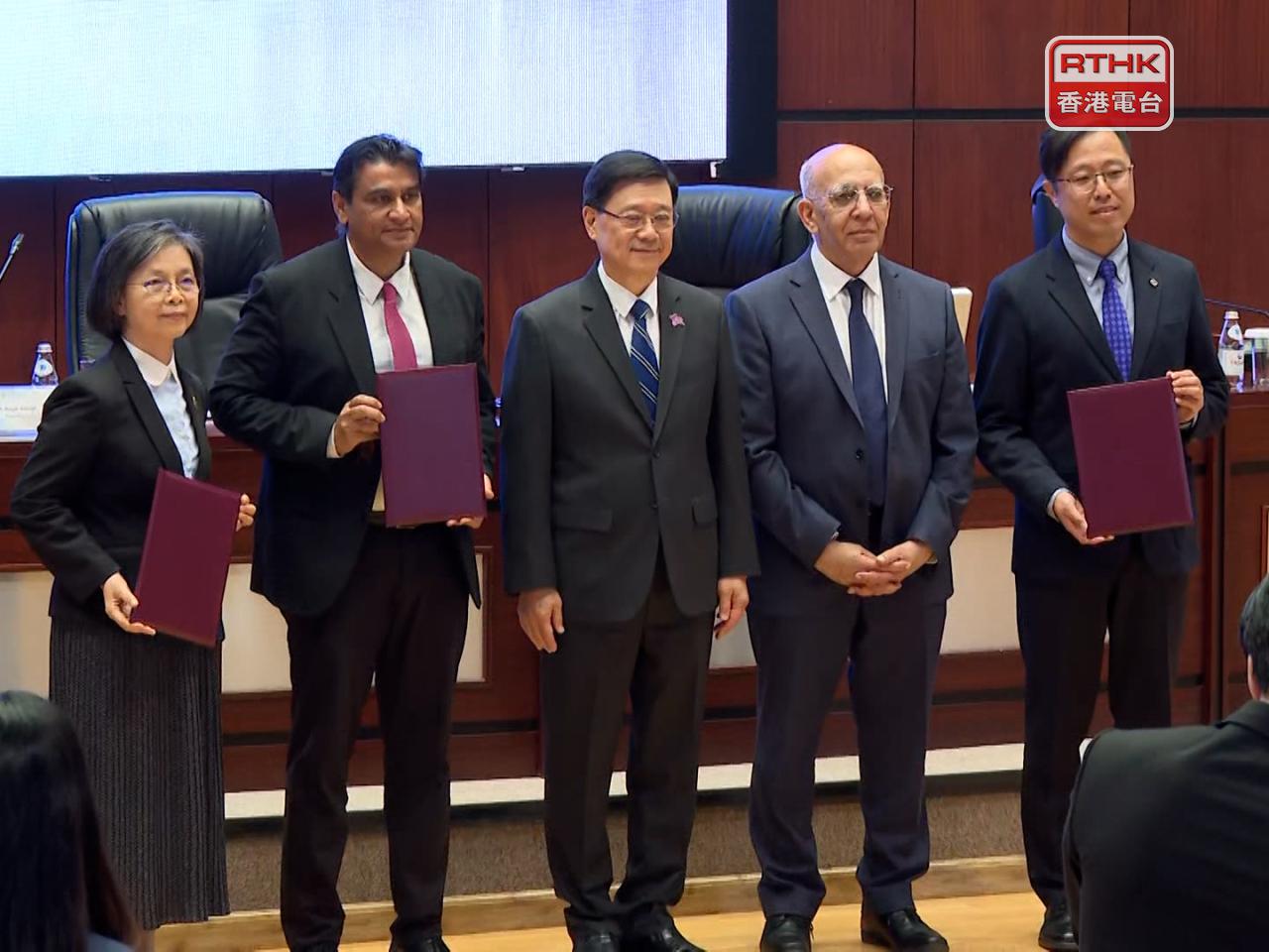 Chief Executive John Lee, centre, witnesses the exchange of memoranda of understanding between two SAR universities and Nazarbayev University. Photo: RTHK