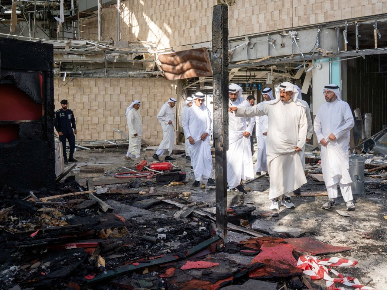 Officials inspect the damage at Kuwait International Airport after an attack that killed one person and injured scores. Photo: Reuters