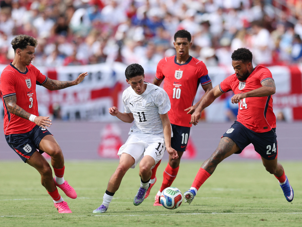 New Zealand's Elijah Just in action with England's Reece James, Nico O'Reilly and Jude Bellingham. Photo: Reuters