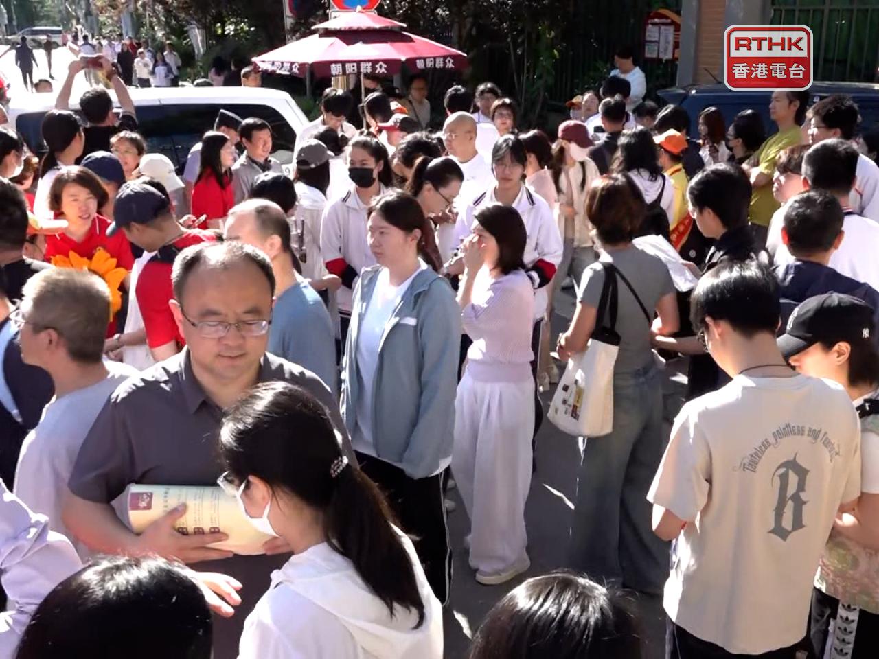 Some parents accompanied their children to the exam venue, and wished them good luck. Photo: RTHK