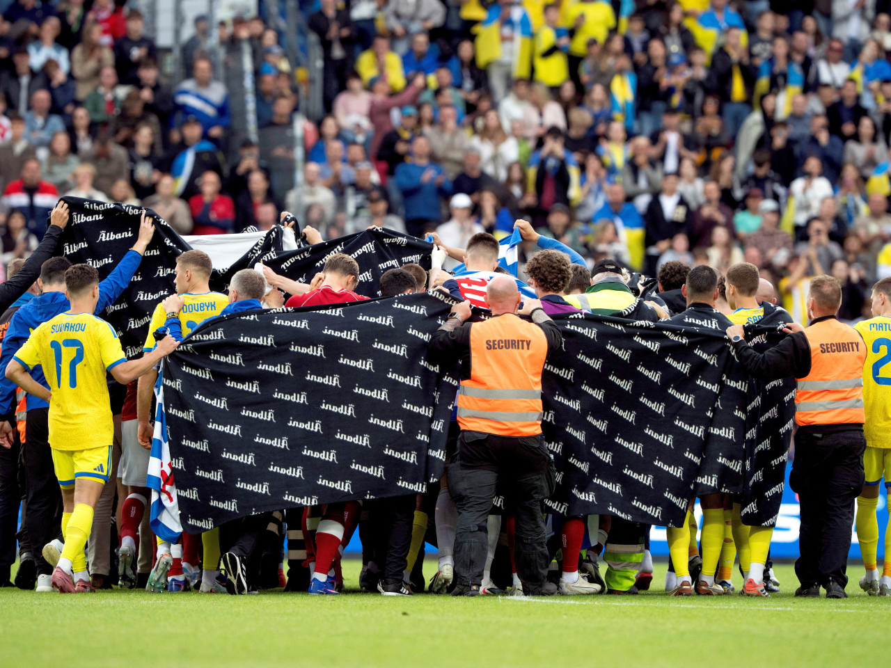 Eriksen's teammates stood around him in a wall as he received medical attention before being carried off on a stretcher. Photo: Reuters