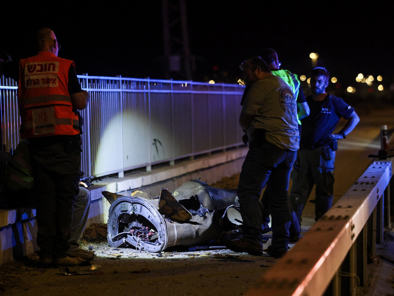 Israeli personnel work next to a part of a projectile following a missile attack from Iran. Photo: Reuters