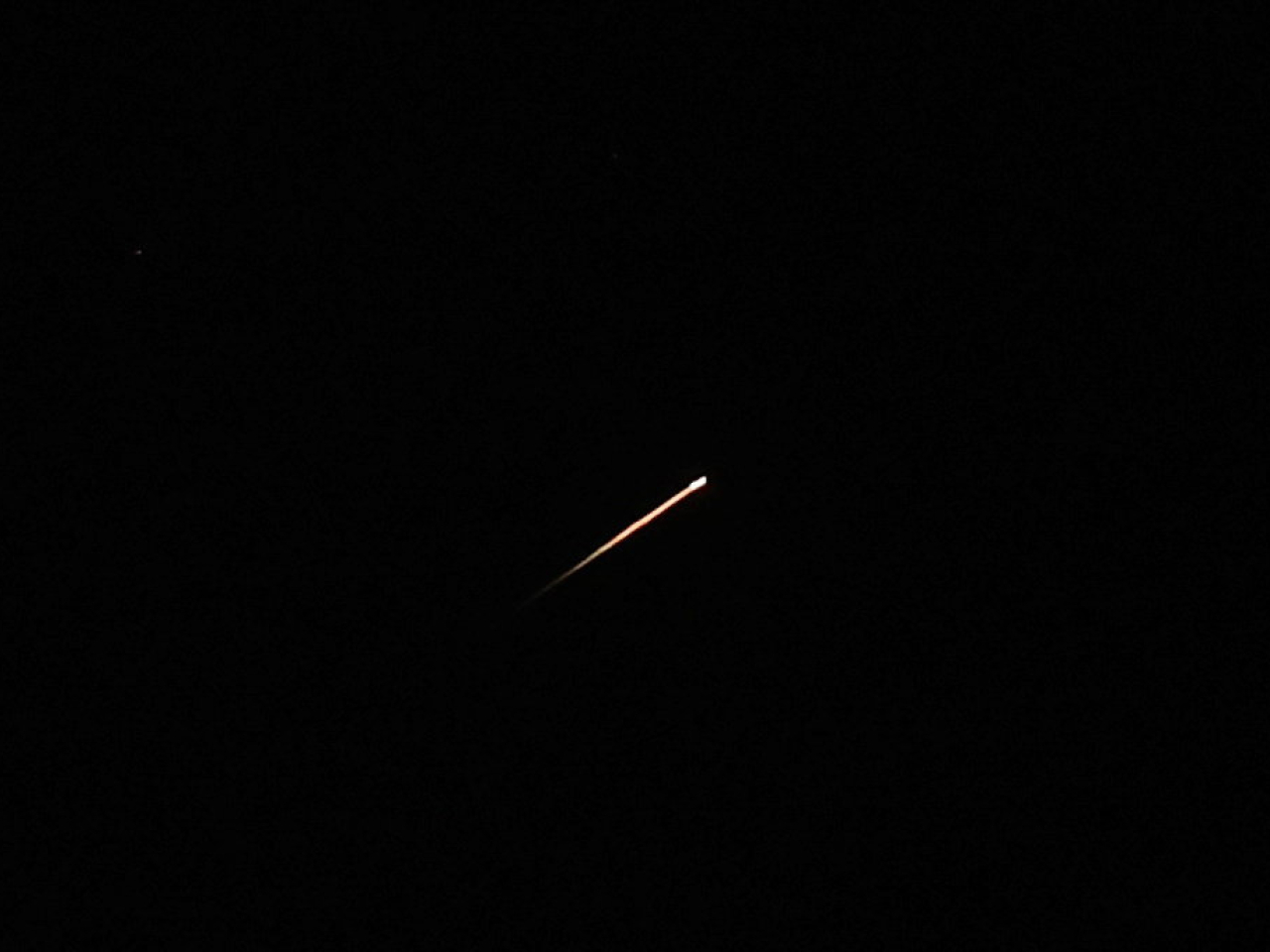 A streak of light illuminates the sky during a missile attack from Iran towards Israel, as seen from Jerusalem. Photo: Reuters
