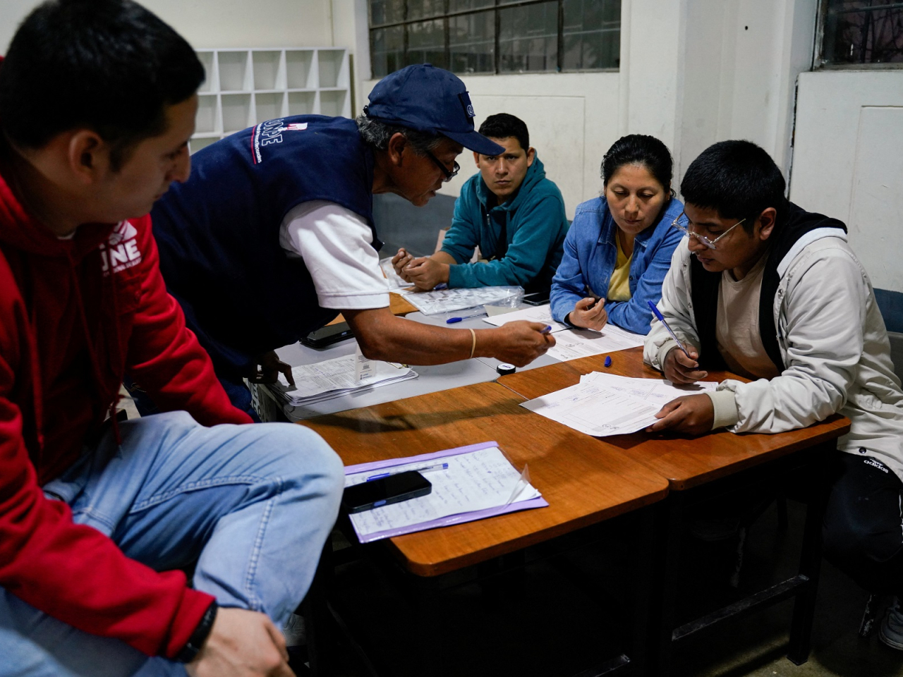 Electoral workers count votes after polls closed in a runoff election between conservative candidate Keiko Fujimori and left-wing candidate Roberto Sanchez. Photo: Reuters