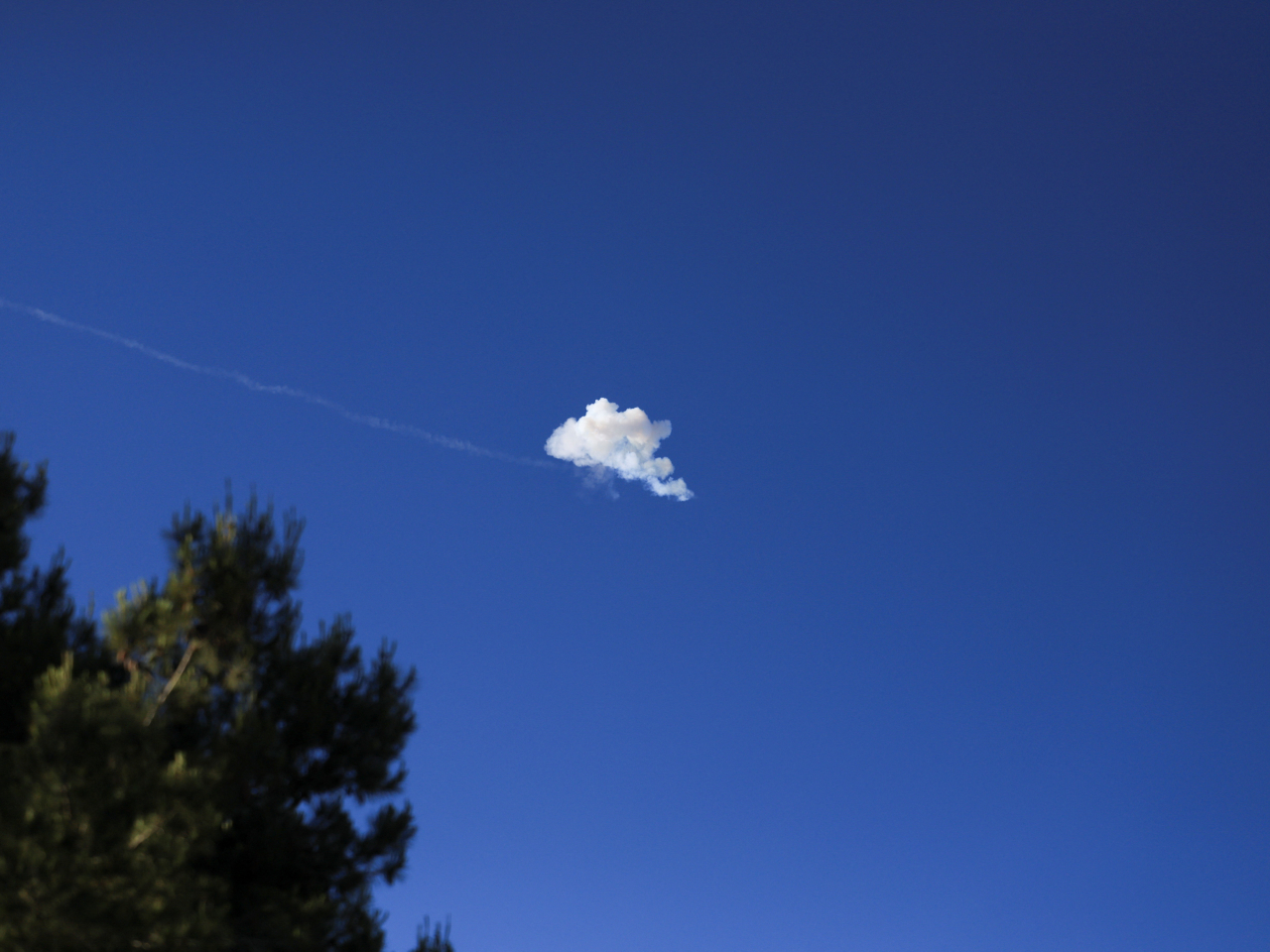 Smoke from an explosion in the sky after the Iron Dome anti-missile system intercepted an Iranian missile, as seen from Jerusalem. Photo: Reuters