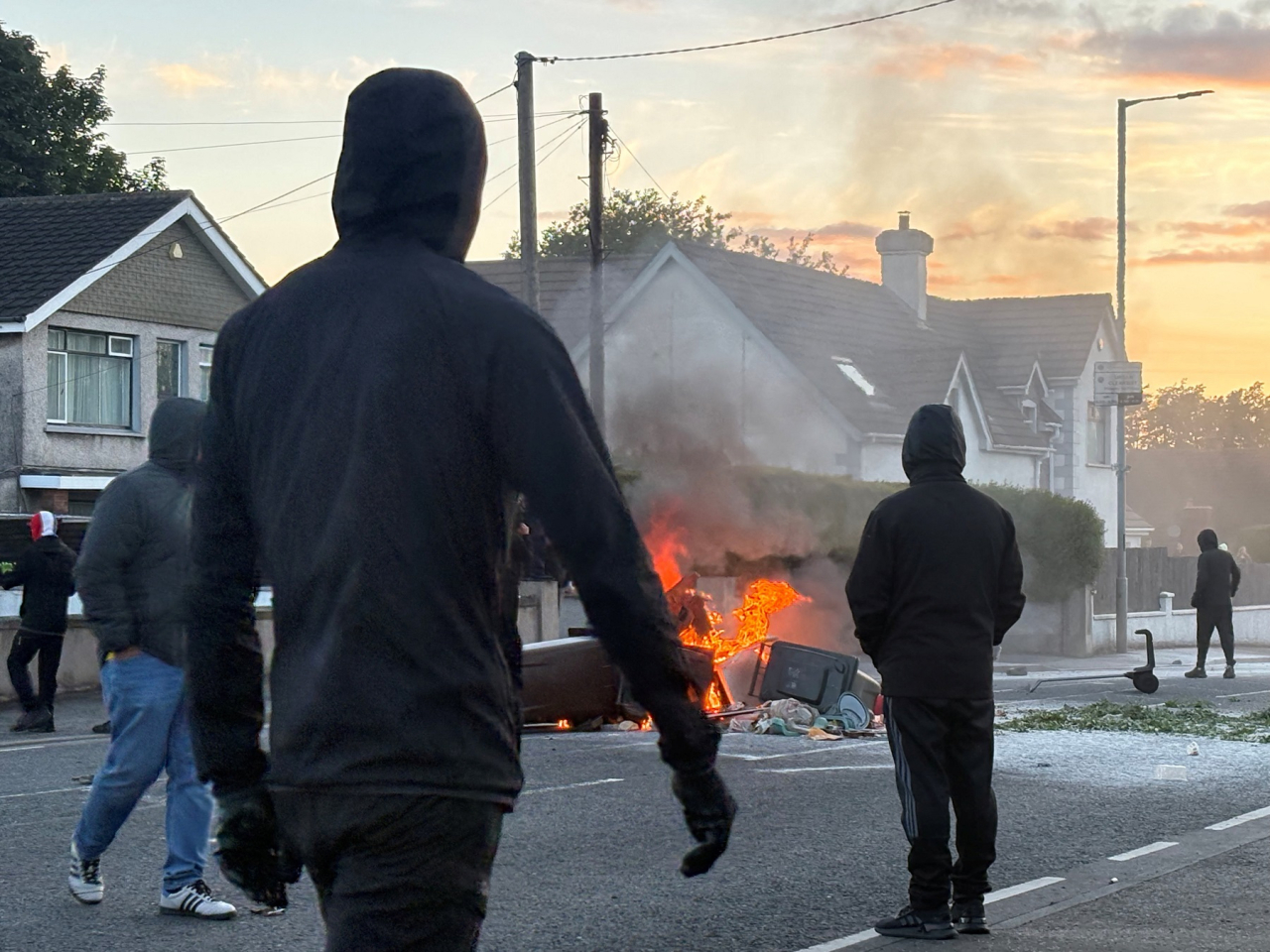A fire burns in bins as anti-immigrant protesters clash with police. Photo: Reuters